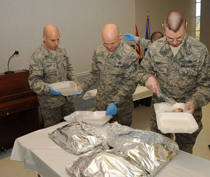 Barksdale First Sergeants prepare to-go boxes for Airmen during a Christmas Lunch on Barksdale Air Force Base, La., Dec. 25, 2013. The boxes were made for 51 Airmen who were working around the base. (U.S. Air Force photo/Staff Sgt. Sean Martin)