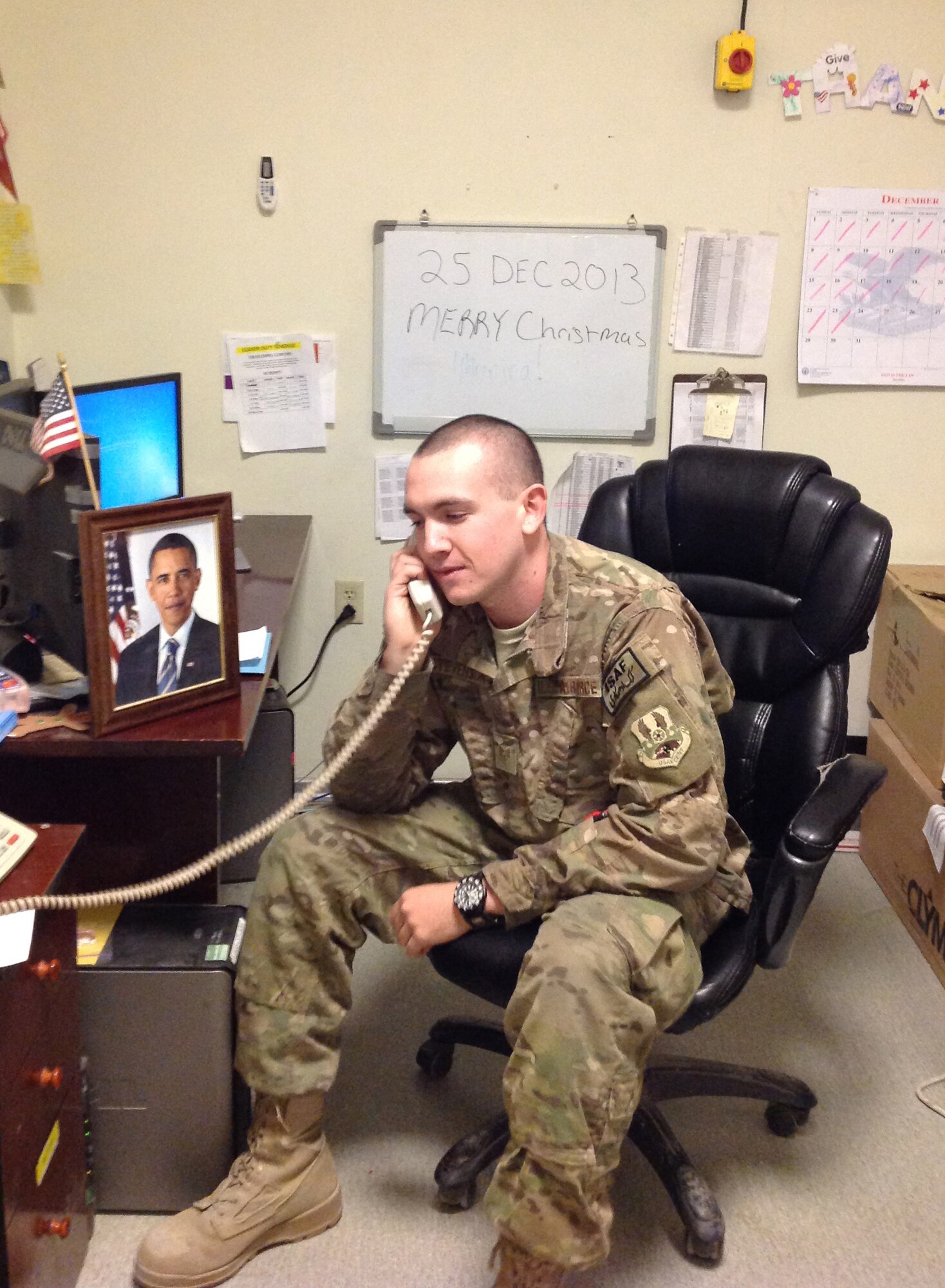 Staff Sergeant Michael Stevenson receives a Christmas Day call from President Barack Obama, Dec. 25th, 2013 at Bagram Airfield, Afghanistan. Every year, the President selects Service members to call and wish them and their family a Merry Christmas. (U.S. Air Force Photo by Master Sergeant Thomas Ward)