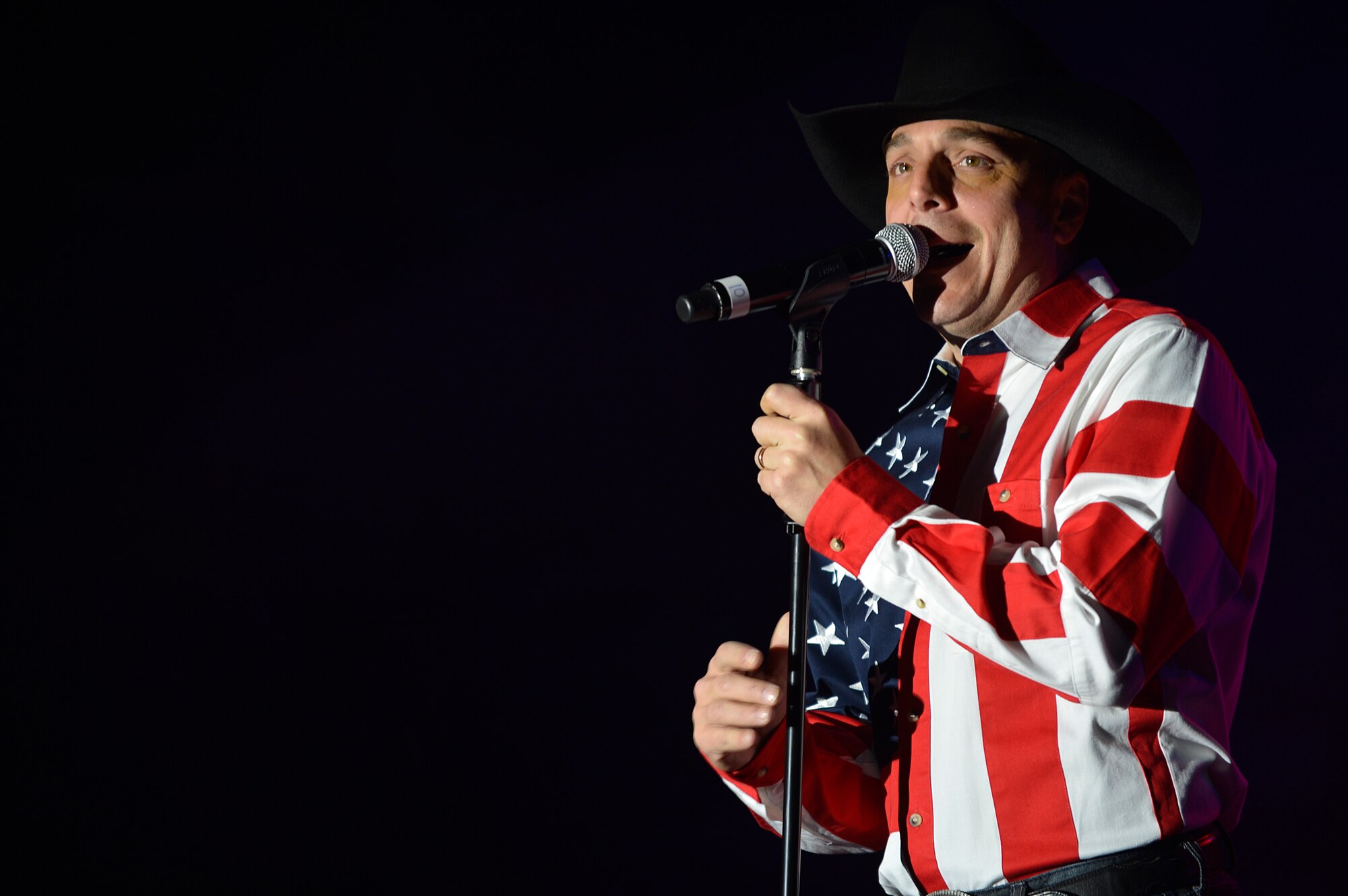 Ryan Daniel, Air Force Entertainment Group vocalist, sings to a deployed Service member at Bagram Airfield, Afghanistan, Dec. 24, 2013. The Air Force Entertainment Group comprised of 27 former Tops in Blue members, performed a holiday show for deployed Service members. (U.S. Air Force photo by Senior Airman Kayla Newman/Released)