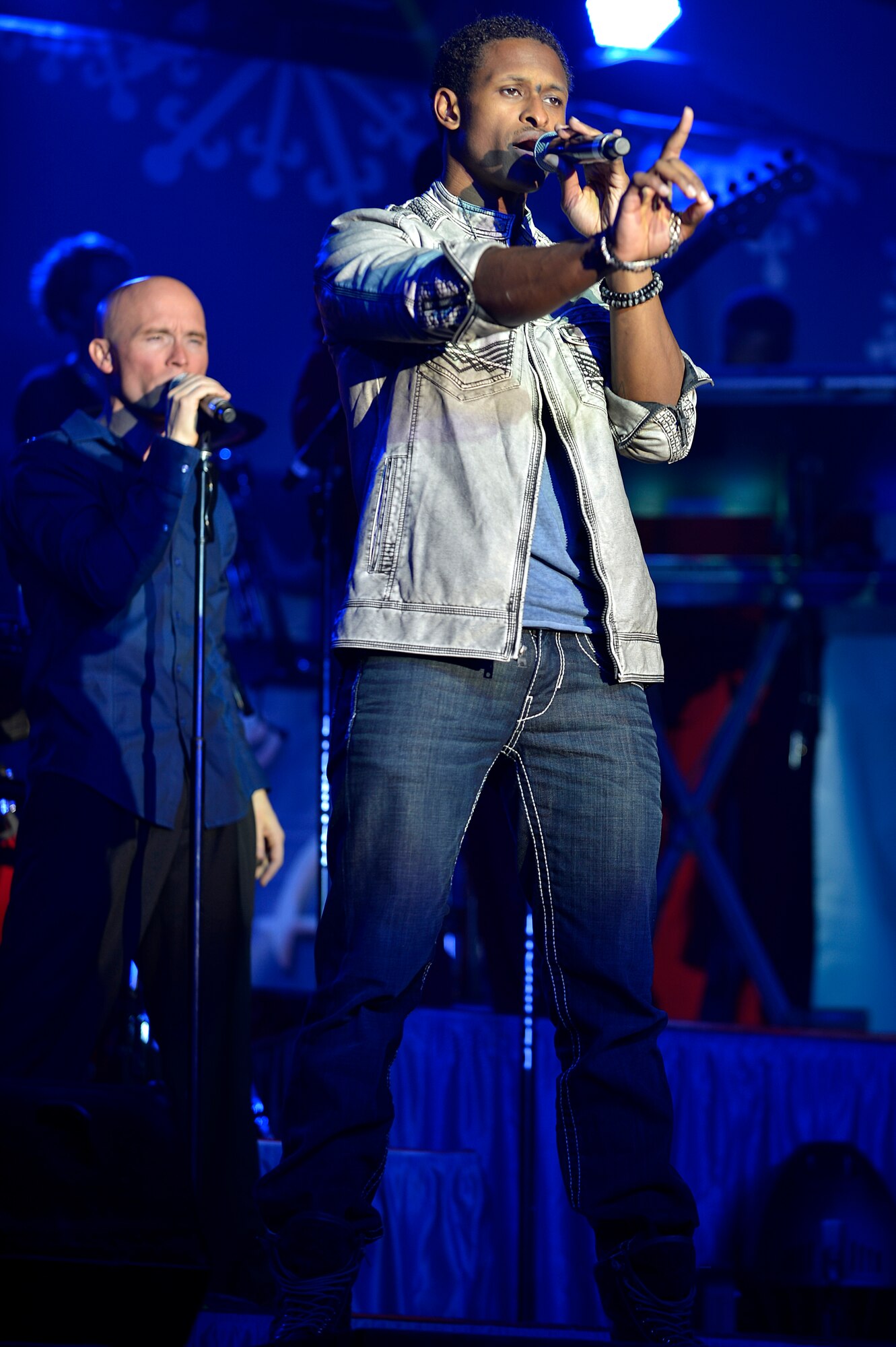 Jerome “J ROME” Wayne, Air Force Entertainment Group vocalist, performs for deployed Service members at Bagram Airfield, Afghanistan, Dec. 24, 2013. The Air Force Entertainment Group comprised of 27 former Tops in Blue members, performed a holiday show for deployed Service members. (U.S. Air Force photo by Senior Airman Kayla Newman/Released)