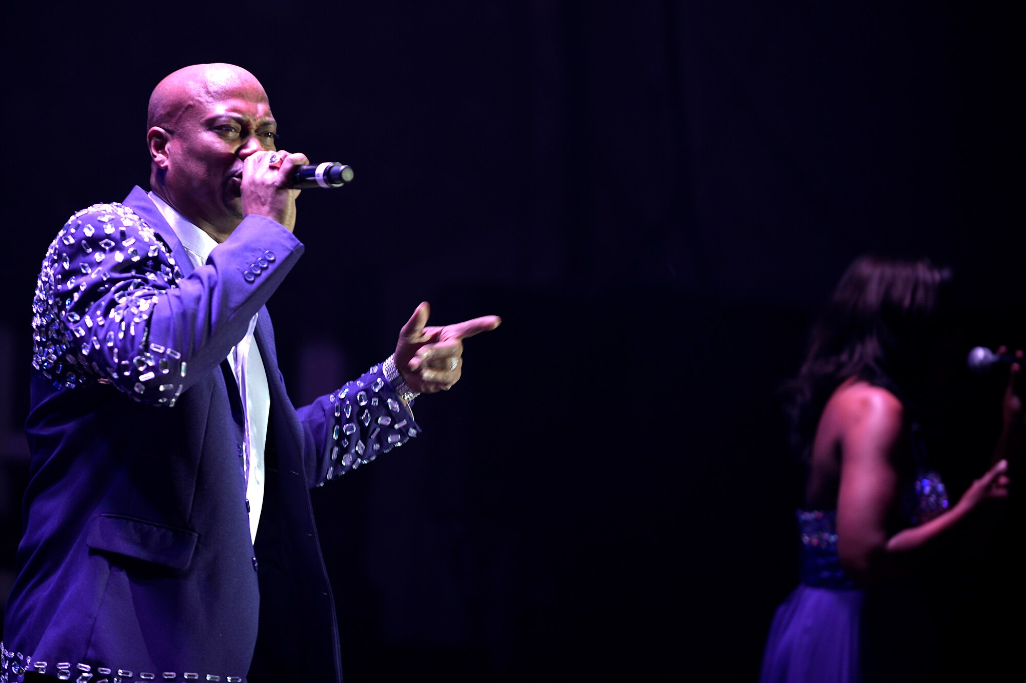 Lane McCray, Air Force Entertainment Group vocalist, performs for deployed Service members at Bagram Airfield, Afghanistan, Dec. 24, 2013. After an enlistment in the U.S. Air Force, McCray became a member of the europop group “La Bouche.” (U.S. Air Force photo by Senior Airman Kayla Newman/Released)