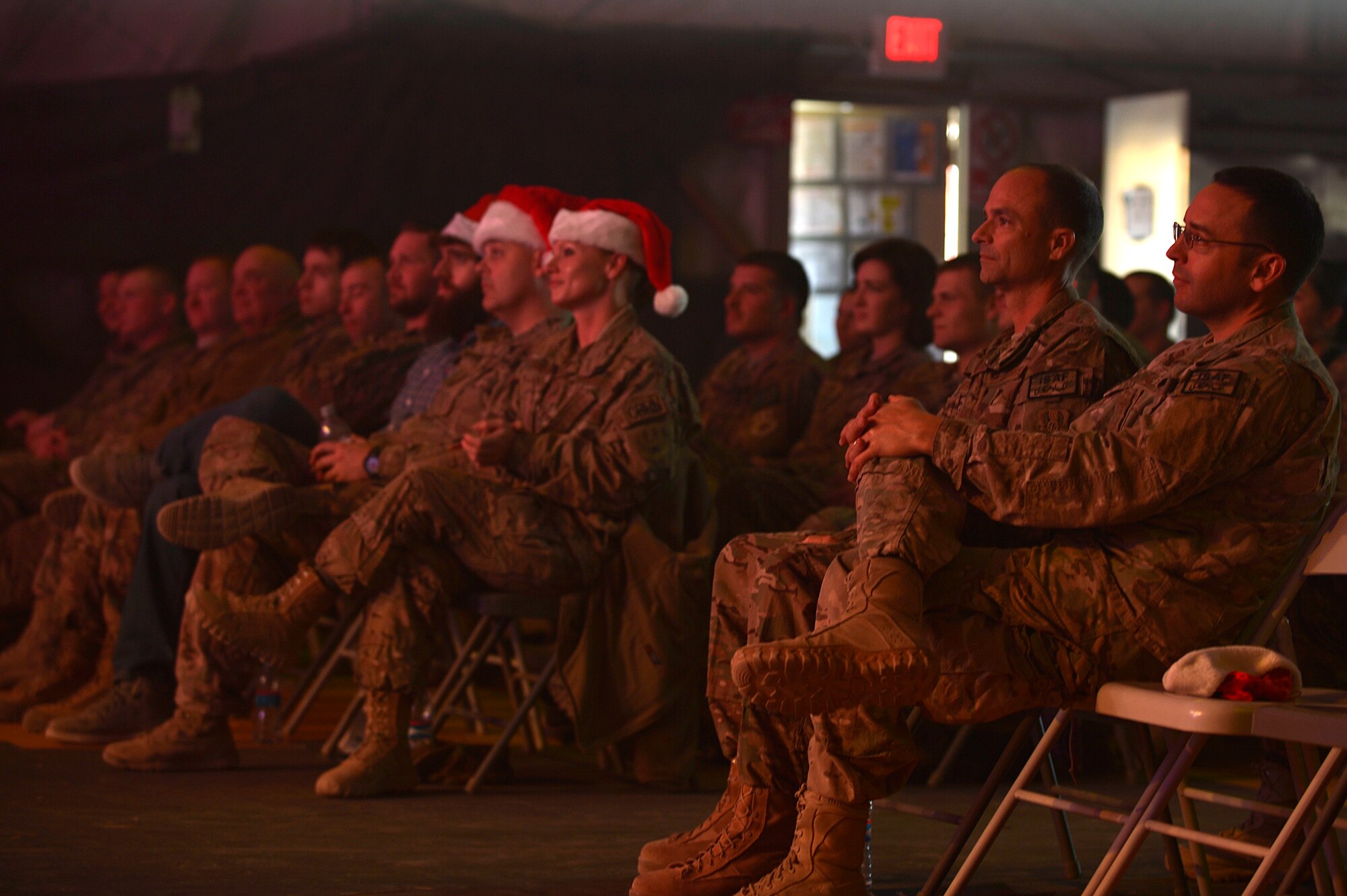 Service members watch a holiday performance by the Air Force Entertainment Group comprised of 27 former Tops in Blue members, at Bagram Airfield, Afghanistan, Dec. 24, 2013. The holiday tour includes 15 performances at 10 locations throughout Southwest Asia. (U.S. Air Force photo by Senior Airman Kayla Newman/Released)