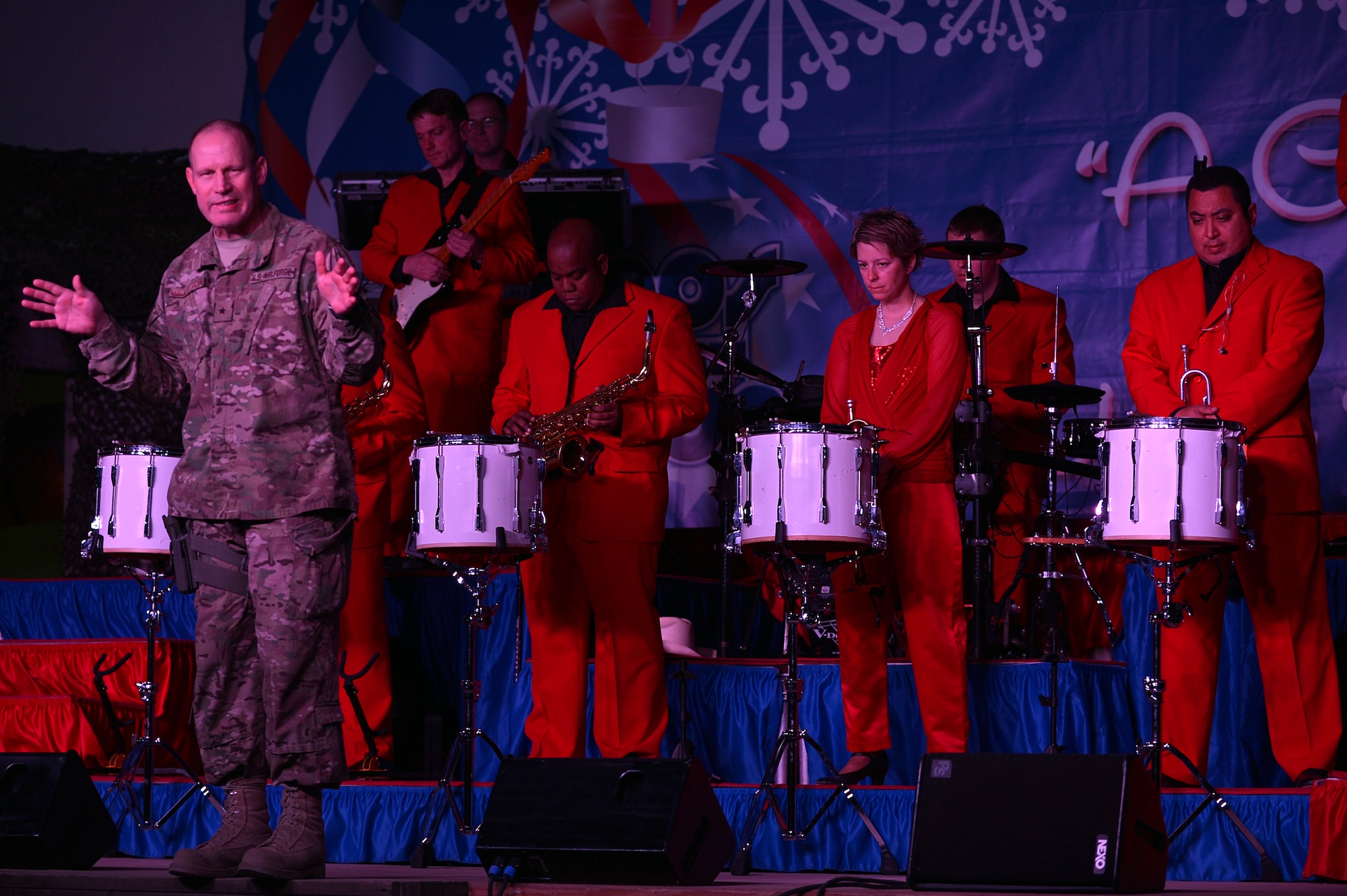 U.S. Air Force Brig. Gen. Patrick C. Malackowski, 455th Air Expeditionary Wing commander, addresses the crowd prior to the Air Force Entertainment Group’s holiday performance at Bagram Airfield, Afghanistan, Dec. 24, 2013. The group is comprised of 27 prior Tops in Blue members, including Tech. Sgt. Angie Johnson, Jerome “JROME” Wayne and Tech. Sgt. Lane McCray. (U.S. Air Force photo by Senior Airman Kayla Newman/Released)