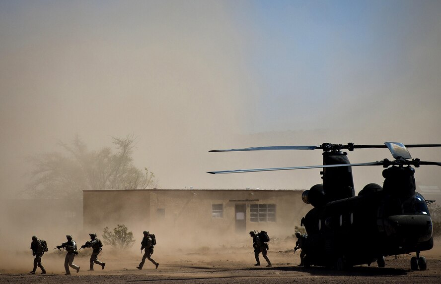 Marines from the 2nd Force Reconnaissance Company evacuate from a CH-47 Chinook helicopter during an urban environment warfare exercise April 18, 2013, at the Playas Training and Research Center at Playas, N.M. The training was part of the world's largest international personnel recovery exercise, Angel Thunder, which included 19 countries from around the world. (U.S. Air Force photo/Senior Airman Andrew Lee)