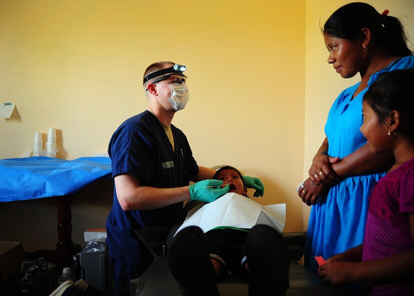 Capt. Daniel Dahl administers anesthesia to a Belizean boy while talking to his mother during a dental readiness training exercise April 26, 2013, at the Punta Gorda Hospital annex in Punta Gorda, Belize. Dental professionals from the U.S. and Canada are providing free dental treatment at multiple readiness training exercises throughout Belize as part of an exercise known as New Horizons. Dahl is a dental resident from Offutt Air Force Base, Neb. (U.S. Air Force photo/Tech. Sgt. Tony Tolley)