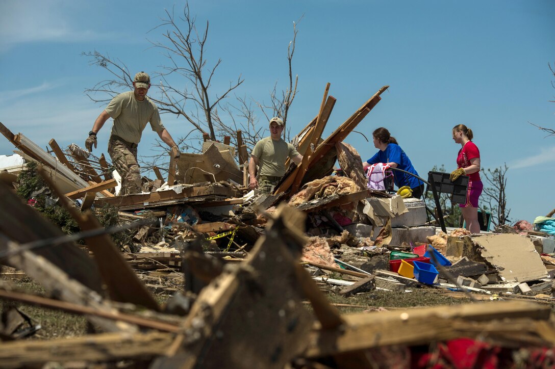Capt. Van Blaylock, left, and Senior Airman Joshua Jacobs help resident Alyson Tinney and Elise Hopkins search through the debris looking for salvageable items May 22, 2013, in Moore, Okla. On May 20, 2013, an EF-5 tornado, with winds reaching at least 200 mph, traveled for 20 miles, leaving a two-mile-wide path of destruction, leveling homes, crushing vehicles and killing more than 20 people. More than 115 Oklahoma National Guard members were activated to assist in the rescue and relief efforts. Blaylock and Jacobs are joint terminal attack controllers assigned to the 146th Air Support Operations Squadron. (U.S. Air Force photo/Staff Sgt. Jonathan Snyder)