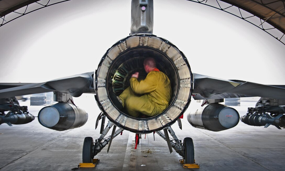 Senior Airman Nate Hall conducts a post-flight inspection on an F-16 Fighting Falcon July 5, 2013, at Kandahar Airfield, Afghanistan. Maintainers inspect everything on the aircraft for leaks or cracks or anything that may jeopardize the integrity of the aircraft. Hall is deployed from Spangdahlem Air Base, Germany, and is a Bellevue, Neb., native. (U.S. Air Force photo/Senior Airman Scott Saldukas)