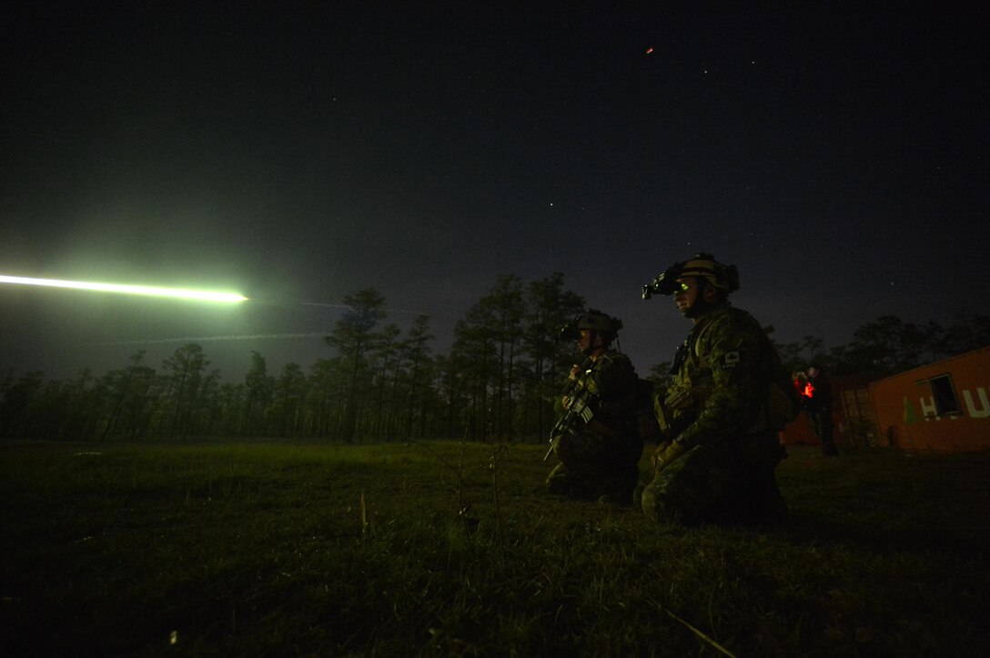 Canadian special operation regiment members call in close air support from their U.S. Air Force allies April 26, 2013, during Emerald Warrior 2013, Hurlburt Field, Fla. The primary purpose of Emerald Warrior is to exercise special operations components in urban and irregular warfare settings to support combatant commanders. Emerald Warrior leverages lessons from Operation Iraqi Freedom, Operation Enduring Freedom and other historical lessons to provide better trained and ready forces to combatant commanders. (U.S. Air Force photo/Senior Airman Matthew Bruch)
