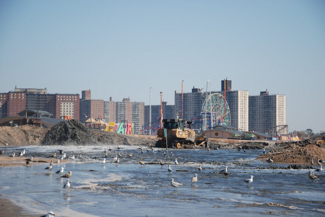 Coney Island landmarks are visible as crews work to place sand and restore the beach at Coney Island Friday September 20, 2013. The U.S. Army Corps of Engineers is placing roughly 600,000 cubic yards of sand at Coney Island to replace sand lost during Hurricane Sandy and also to restore the Coney Island project to its original design profile from when the coastal storm risk reduction project (primarily the beach) was originally constructed in the 1990s. While the beach is a tremendous recreational asset, it's important to note that the engineered beach is designed to act as a buffer and reduce risks to the community from coastal storms like Hurricane Sandy.