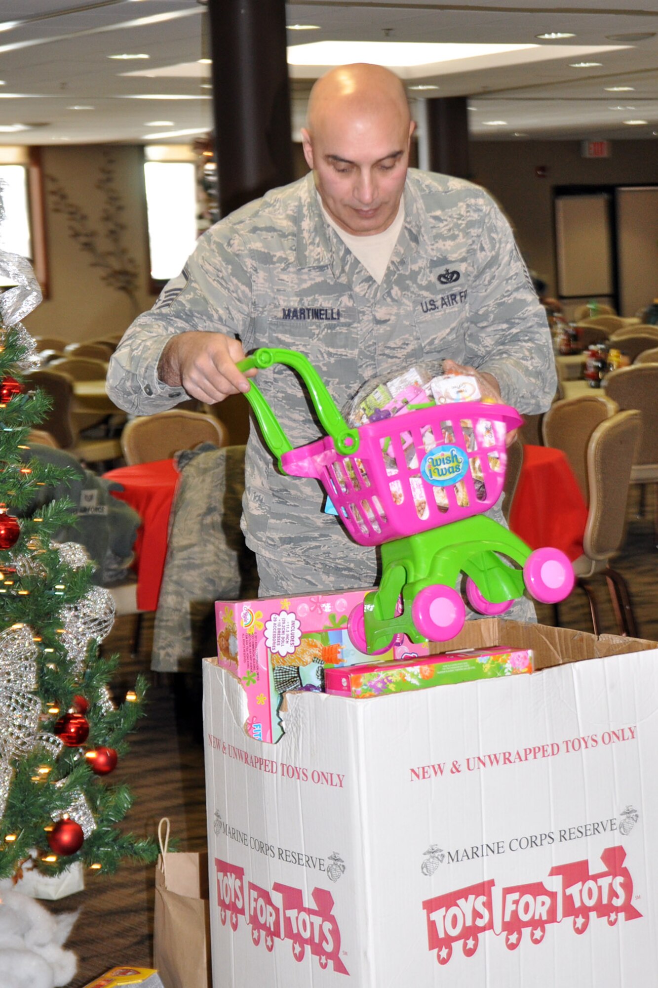 YOUNGSTOWN AIR RESERVE STATION, Ohio – Air Force Reserve Master Sgt. John Martinelli, an electrician assigned to the 910th Civil Engineer Squadron, loads a “Toys for Tots” collection box with a variety of toys at the Community Activity Center here, Dec. 19, 2013. Each year 910th Airlift Wing Citizen Airmen and Department of Defense personnel, assigned here, work with the YARS-based U.S. Marine Corps Reserve unit to collect new, un-wrapped toys for area boys and girls (newborn through 16 years of age) to provide a gift for Christmas morning the children might otherwise not receive. Hundreds and hundreds of toys were collected across the air station and throughout the local community as well as monetary donations used to purchase additional toys. The toys were then distributed by the Marines to children in need across the Mahoning Valley just in time for Christmas day. U.S. Air Force photo by Master Sgt. Bob Barko Jr.