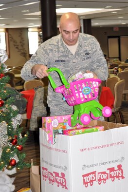 YOUNGSTOWN AIR RESERVE STATION, Ohio – Air Force Reserve Master Sgt. John Martinelli, an electrician assigned to the 910th Civil Engineer Squadron, loads a “Toys for Tots” collection box with a variety of toys at the Community Activity Center here, Dec. 19, 2013. Each year 910th Airlift Wing Citizen Airmen and Department of Defense personnel, assigned here, work with the YARS-based U.S. Marine Corps Reserve unit to collect new, un-wrapped toys for area boys and girls (newborn through 16 years of age) to provide a gift for Christmas morning the children might otherwise not receive. Hundreds and hundreds of toys were collected across the air station and throughout the local community as well as monetary donations used to purchase additional toys. The toys were then distributed by the Marines to children in need across the Mahoning Valley just in time for Christmas day. U.S. Air Force photo by Master Sgt. Bob Barko Jr.