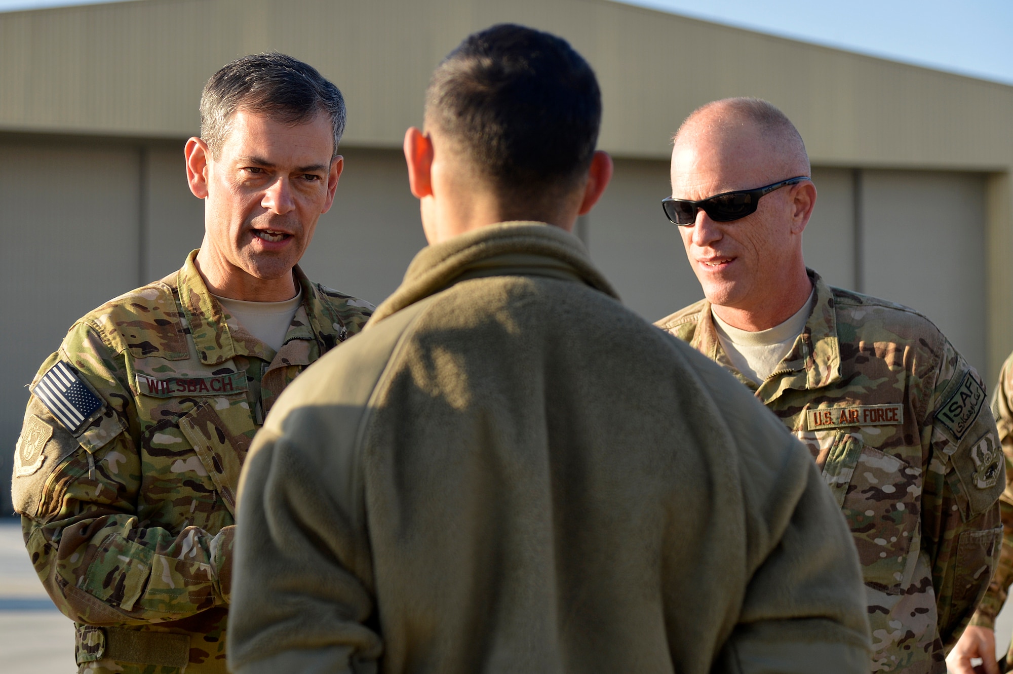 U.S. Air Force Maj. Gen. Kenneth Wilsbach, 9th Air and Space Expeditionary Task Force- Afghanistan; Deputy Commander -Air, U.S. Forces - Afghanistan; Deputy Chief of Staff - Air, International Security Assistance Force Joint Command, talks with a C-130 maintainer during a tour at Bagram Airfield, Afghanistan, Dec. 25, 2013. Wilsbach also visited Service members at the Craig Joint Theater Hospital, an entry control point, the F-16 Fighting Falcon hangar, the A-10 Thunderbolt II hangar and the HH-60G Pavehawk hangar. (U.S. Air Force photo by 