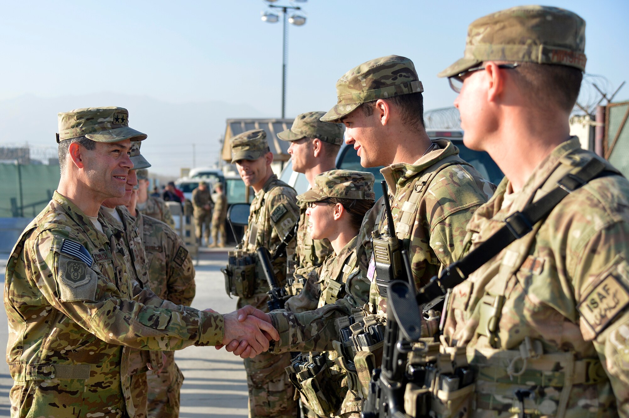 U.S. Air Force Maj. Gen. Kenneth Wilsbach, 9th Air and Space Expeditionary Task Force- Afghanistan; Deputy Commander -Air, U.S. Forces - Afghanistan; Deputy Chief of Staff - Air, International Security Assistance Force Joint Command, greets Airmen at an entry control point at Bagram Airfield, Afghanistan, Dec. 25, 2013. Wilsbach also visited Service members at the Craig Joint Theater Hospital, the C-130 ramp, the F-16 Fighting Falcon hangar, the A-10 Thunderbolt II hangar and the HH-60G Pavehawk hangar. (U.S. Air Force photo by Senior Airman Kayla Newman/Released)