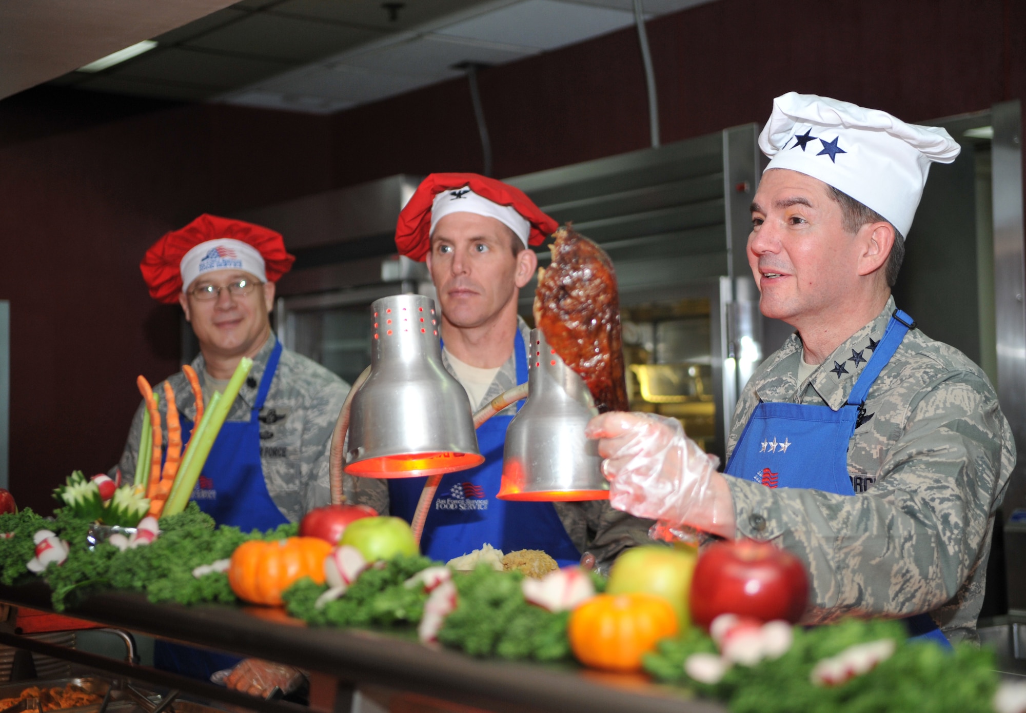 Lt. Gen. Jan-Marc Jouas, 7th Air Force commander, offers a freshly-carved turkey leg to a diner during the Christmas meal in the Gingko Tree dining facility at Osan Air Base, Republic of Korea, Dec. 25, 2013. Osan’s dining facilities are normally only open to active duty service members, but during holiday meals retirees, civilian employees and family members are also welcome. (U.S. Air Force photo/Airman 1st Class Ashley J. Thum)