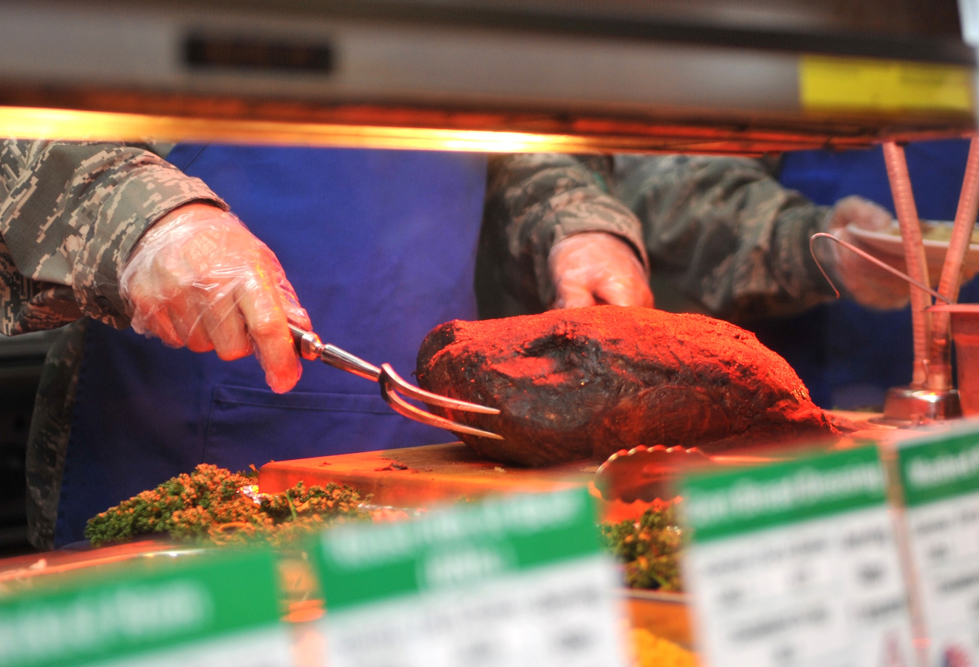 Col. Brook Leonard, 51st Fighter Wing commander, prepares to slice up prime rib for diners during the Christmas meal in the Gingko Tree dining facility at Osan Air Base, Republic of Korea, Dec. 25, 2013. Turkey, ham, shrimp cocktail, stuffing, corn on the cob, sweet potatoes and other vegetables were also on the menu to celebrate the holiday. (U.S. Air Force photo/Airman 1st Class Ashley J. Thum)