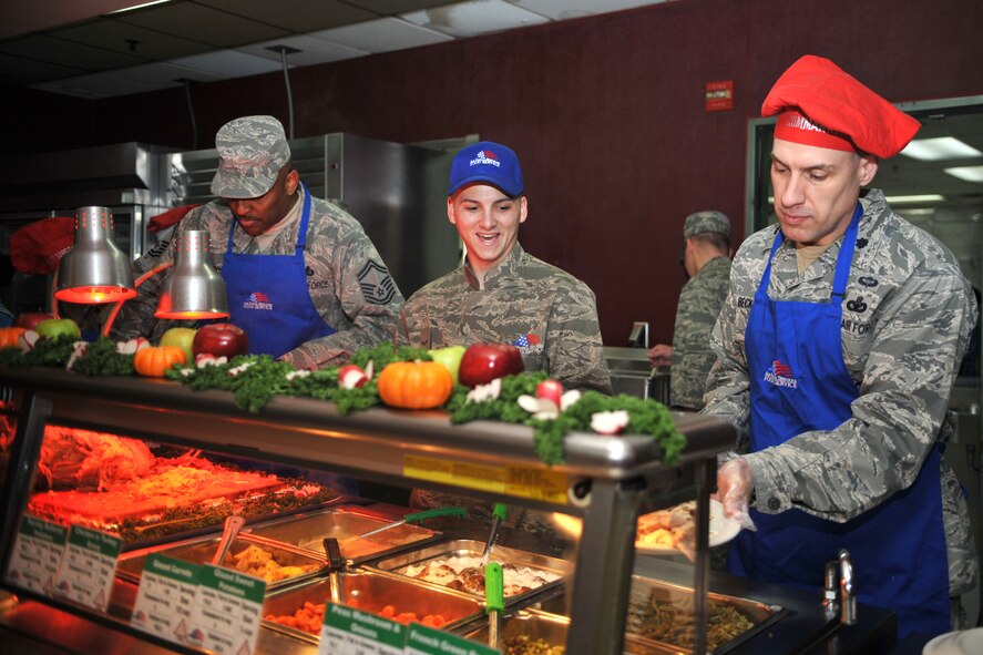 Lt. Col. Jason Beck, 51st Security Forces Squadron commander, adds a side dish to an Airman’s plate during the Christmas meal in the Gingko Tree dining facility at Osan Air Base, Republic of Korea, Dec. 25, 2013. More than 600 Airmen, Soldiers and other patrons gathered at the Gingko Tree to enjoy a homestyle holiday meal. (U.S. Air Force photo/Airman 1st Class Ashley J. Thum)