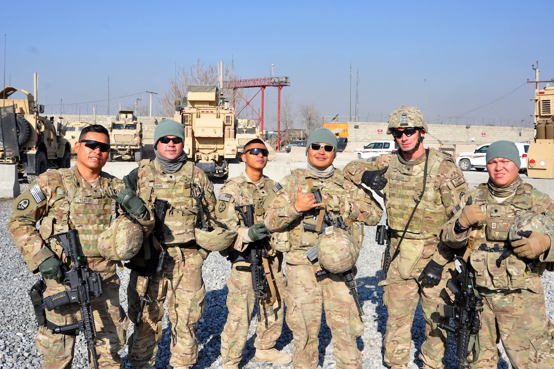 U.S. soldiers pose for a group photograph before departing Camp Phoenix in Kabul, Afghanistan, Dec. 25, 2013.