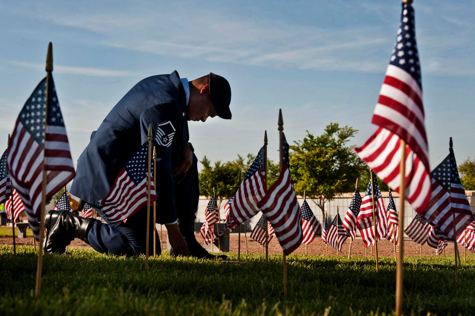 Master Sgt. Robert Lilly pays his respects to a fallen veteran May 28, 2013, at the Southern Nevada Veterans Memorial Cemetery, Boulder City, Nev. Lilly and other Airmen from Nellis Air Force Base, Nev., volunteered their time to place flags over veterans’ cemetery plots for Memorial Day weekend. Lilly is a 57th Operations Group joint tactical air controller. (U.S. Air Force photo/Senior Airman Daniel Hughes)