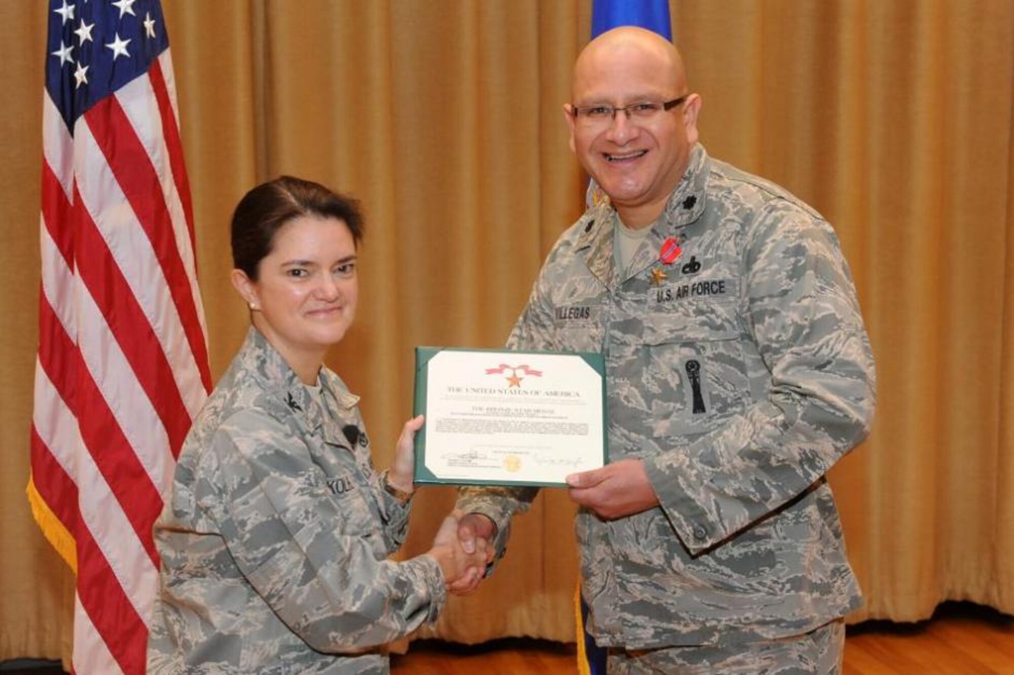 Col. Kathryn Kolbe, 75th Air Base Wing commander, awards Lt. Col. William M. Villegas II, a Bronze Star Dec. 18 at Hill Air Force Base, Utah. Villegas distinguished himself by exceptional meritorious service as a senior logistics advisor, mobile training team, Deputy Command-Support Operations, during Operation Enduring Freedom. He led 300 convoys and 178 missions to implement five logistics trainer courses on Afghan Ministerial Logistics Decrees resulting in nearly a thousand trained Afghan logisticians. (U.S. Air Force photo by Alex R. Lloyd)