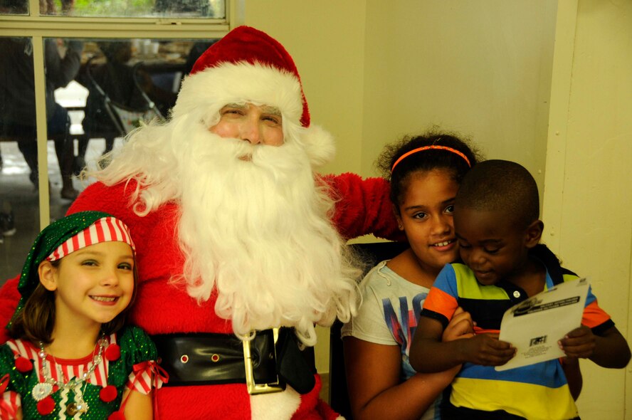 Santa Claus and volunteers from Homestead Air Reserve Base came to greet children at the Chapman Partnership in Homestead, Fla., Dec. 25. Chapman Partnership, a local organization helping to combat homelessness, provides comprehensive services to empower homeless residents to become self-sufficient. (U.S. Air Force photo/Senior Airman Nicholas Caceres)