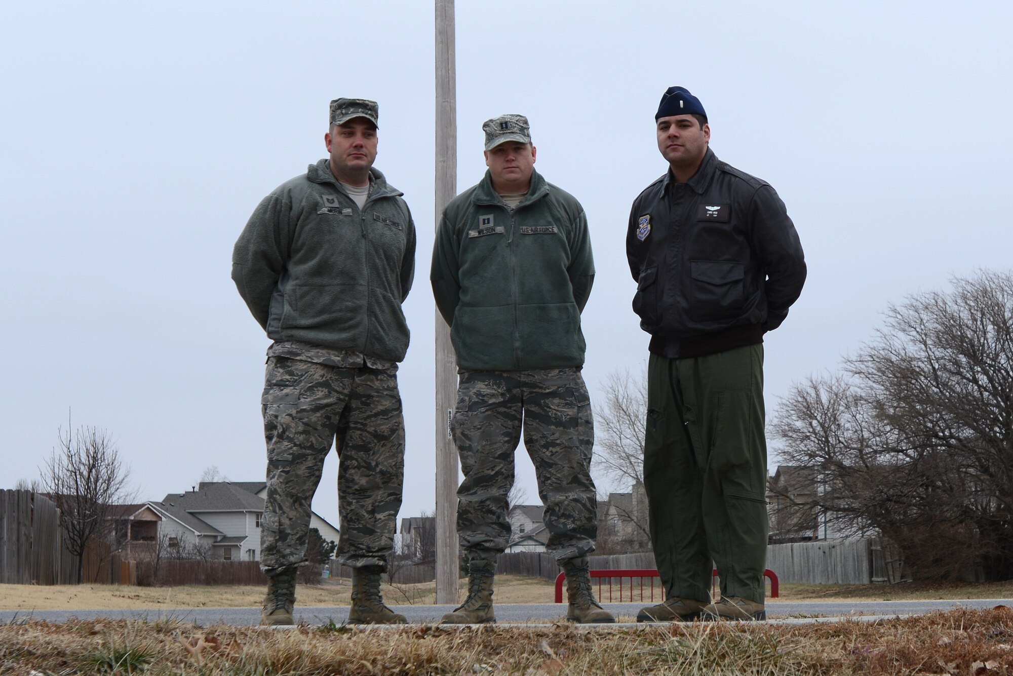 (From left to right) Tech. Sgt. Michael Morin, 22nd Aircraft Maintenance Squadron, Capt. Benjamin Wilson, 22nd Medical Support Squadron, and 1st Lieutenant Christopher Akui, 350th Air Refueling Squadron, pose for a photo near a crash scene in Wichita, Ks, Dec. 16, 2013.   The Airmen acted as first responders to a crash that resulted in the death of one death, and injuries to two others. (U.S. Air Force photo/Senior Airman Trevor Rhynes)