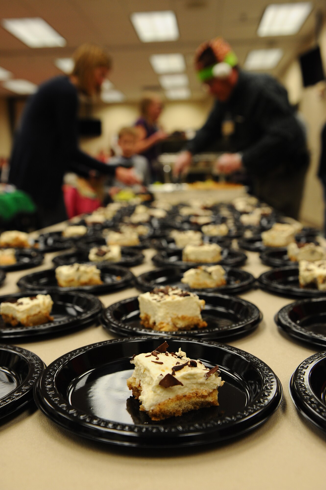 Family members of deployed-military members enjoy a dinner provided by the Airman & Family Readiness center Dec. 20, 2013, at the chapel on Buckley Air Force Base, Colo.  The gathering is an event that allows the families of deployed-servicemembers to meet with and enjoy the company of others. The holiday celebration included a catered dinner, presents for the children, live music and several door prizes. (U.S. Air Force photo by Senior Airman Phillip Houk/Released)