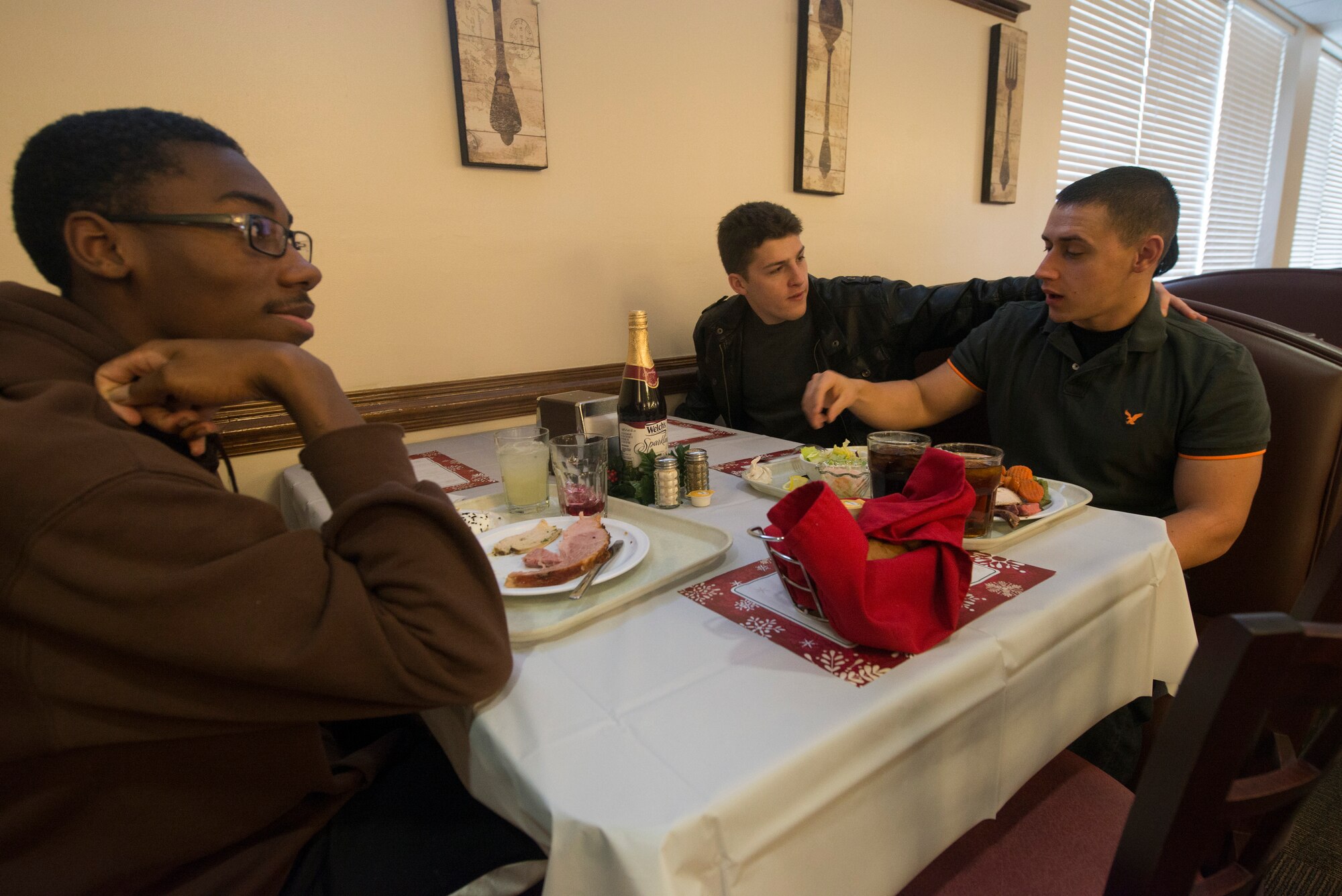 Moody dorm residents take part in their meal during Christmas lunch service at the Georgia Pines Dining Facility at Moody Air Force Base, Ga., Dec. 25, 2013. Family members of Moody leadership delivered bread baskets, eggnog and coffee to Moody Airmen and local Moody residents in attendance. (U.S. Air Force photo by Airman Dillian Bamman/Released)