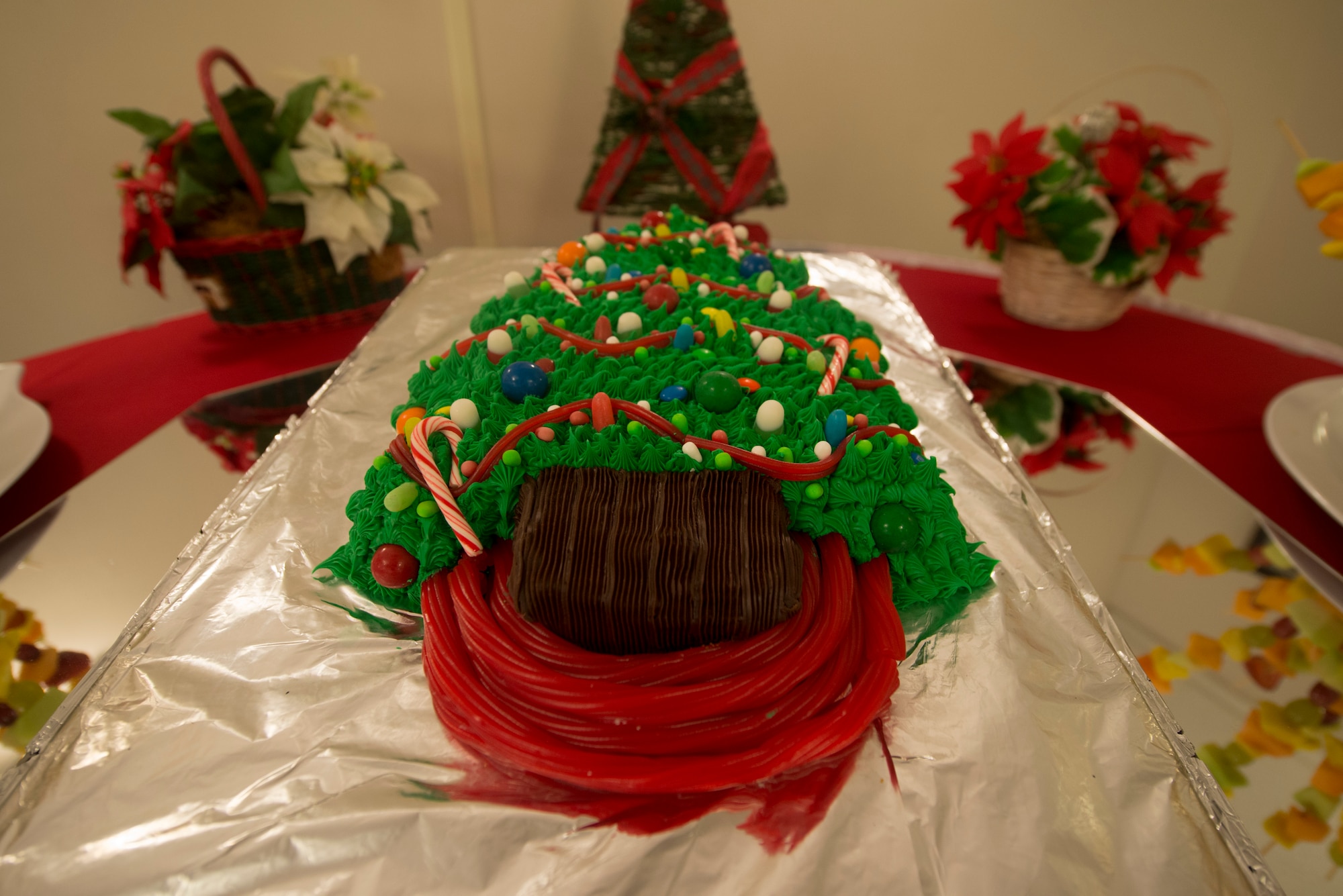 A Christmas tree cake sits at the desert table during Christmas lunch service at the Georgia Pines Dining Facility at Moody Air Force Base, Ga., Dec. 25, 2013. The cake was decorated using red licorice, chocolate cake and various ornamented candies. (U.S. Air Force photo by Airman Dillian Bamman/Released)