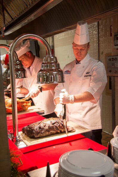 U.S. Air Force 1st Lt. Steven Stanton, 23d Civil Engineer Squadron, carves roast beef during Christmas lunch service at the Georgia Pines Dining Facility on Moody Air Force Base, Ga., Dec. 25, 2013. Moody leadership and their families helped serve meals to Airmen, local retirees and their guests. (U.S. Air Force photo by Airman Dillian Bamman/Released)

