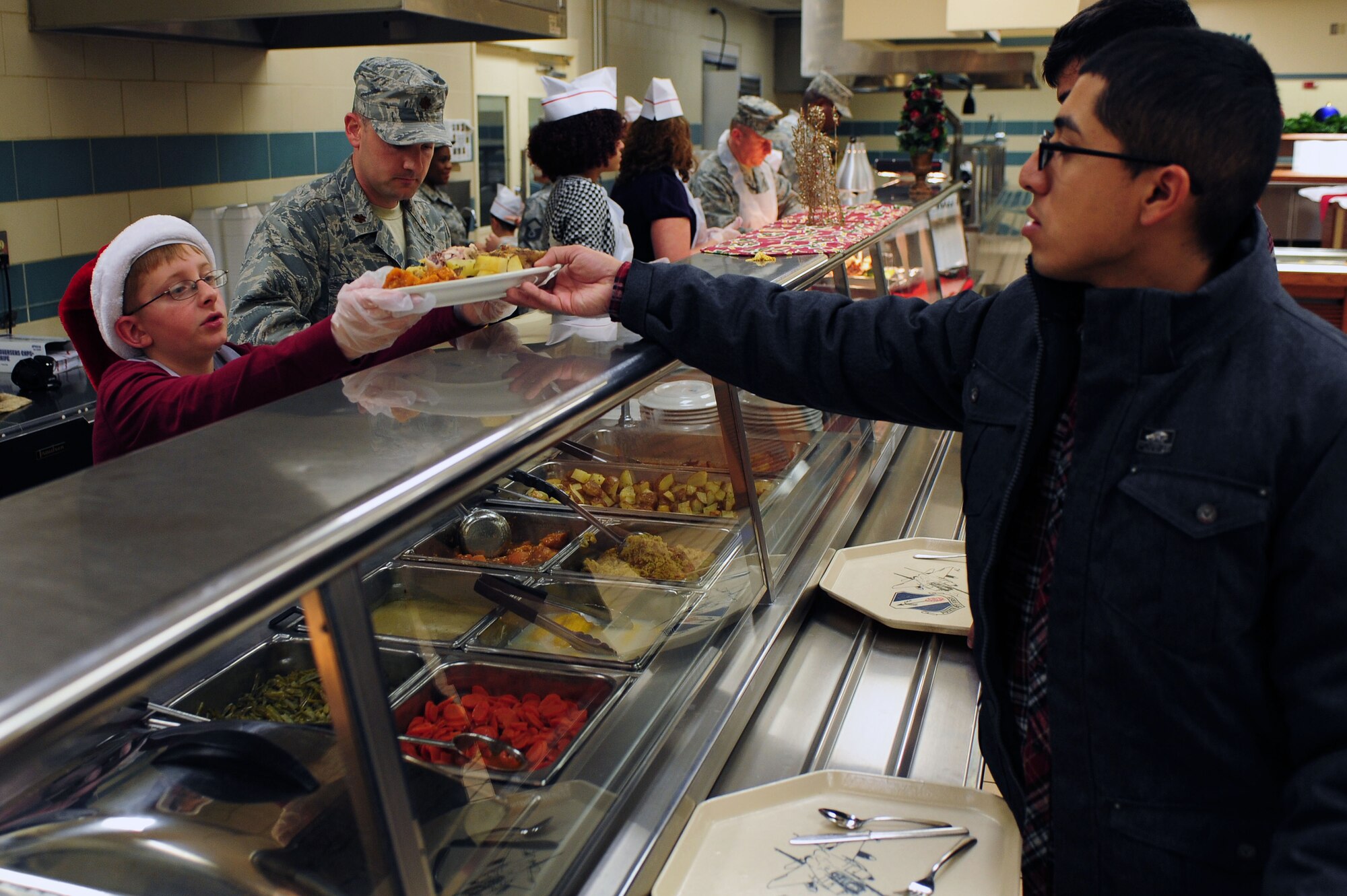 Volunteers, along with 4th Fighter Wing leadership, served holiday meals at the Southern Eagle Dining Facility on Seymour Johnson Air Force Base, N.C., Dec. 25, 2013. More than 100 individuals were served a holiday meal this year. (U.S. Air Force photo by Senior Airman John Nieves Camacho)