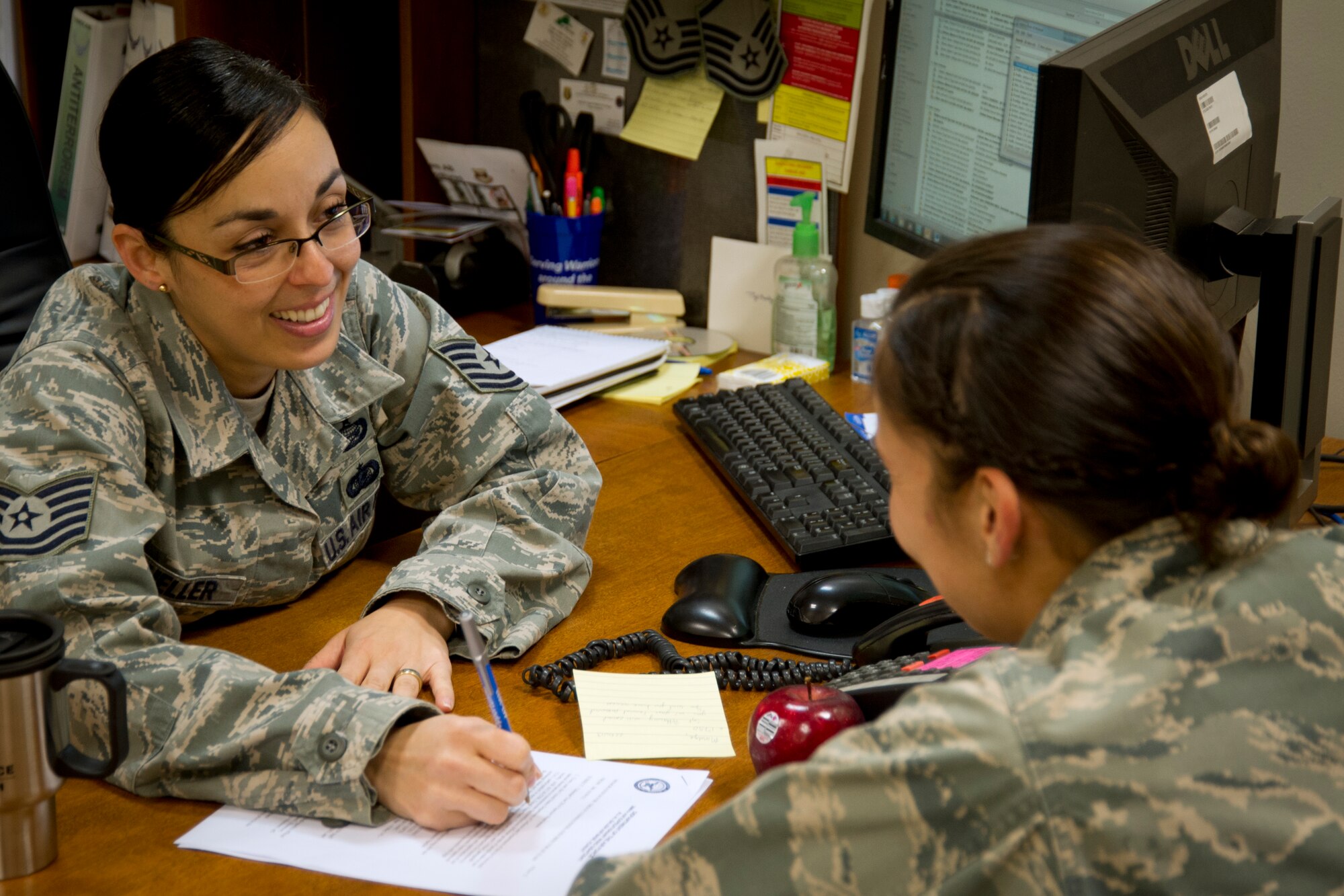 Tech. Sgt. Maritza Mueller, Equal Opportunity Regional Director with the 386th Air Expeditionary Wing, undisclosed location, Southwest Asia, converses with her collegue, 1st Lt. Natalie Campos, the 386th AEW Sexual Assault Coordinator.  Mueller, who is deployed from Barksdale Air Force Base, La., has recently been honored with Global Strike Command's Equal Opportunity Director of the Year award.  She will go on to compete against other MAJCOM winners for the Air Force level award.  (U.S. Air Force photo by Senior Master Sgt. Burke Baker)