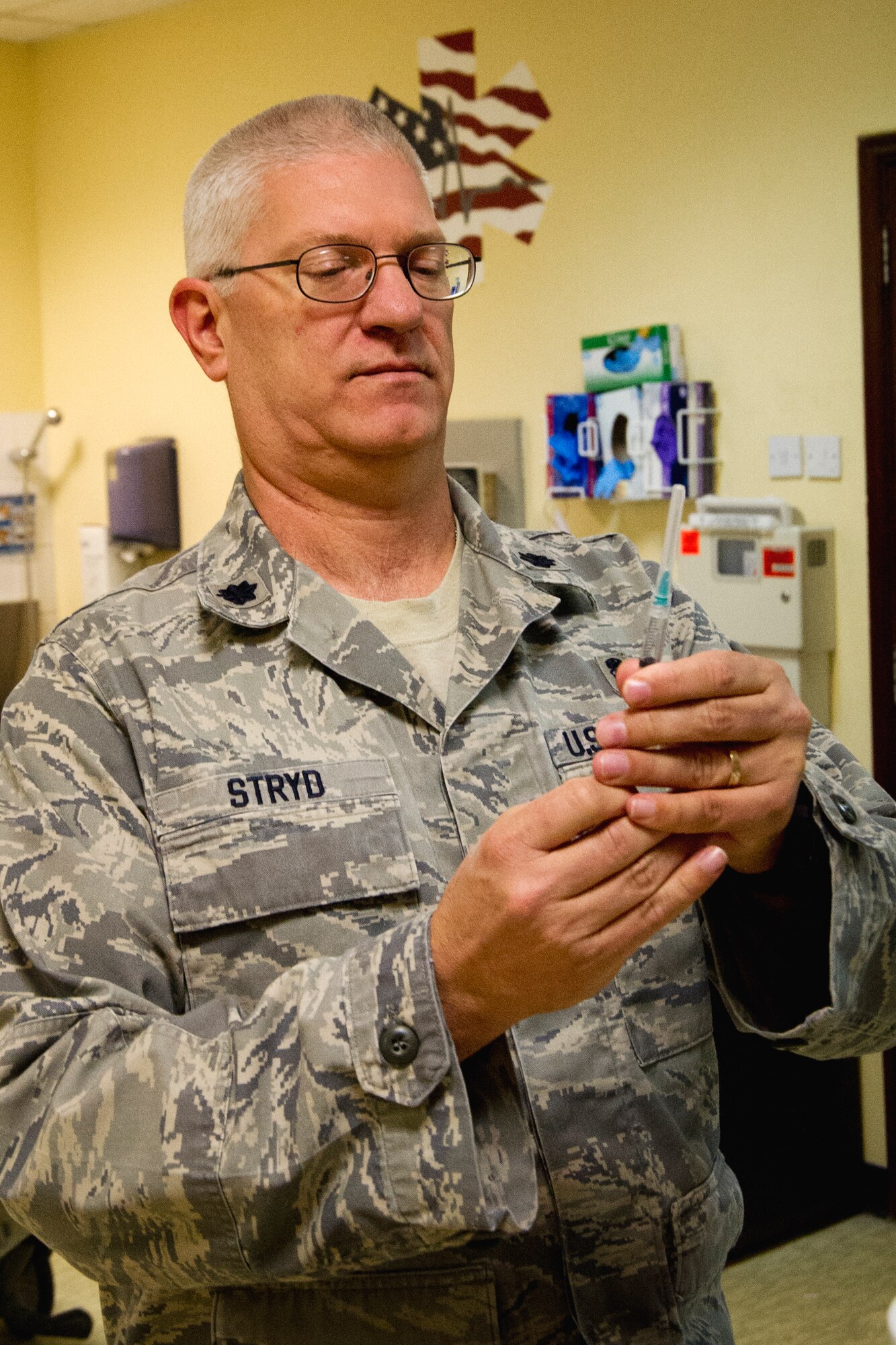 Lt. Col. James Stryd, 386th Expeditionary Medical Group, prepares a saline syringe.  Stryd, who is deployed from Fairchild Air Force Base, Wash., has recently been honored with Air Mobility Command's Outstanding Excellence in Nursing Leadership award.  He will go on to compete against other MAJCOM winners for the Air Force level award.  Stryd is originally from Hanford, Calif.  (U.S. Air Force photo by Senior Master Sgt. Burke Baker)