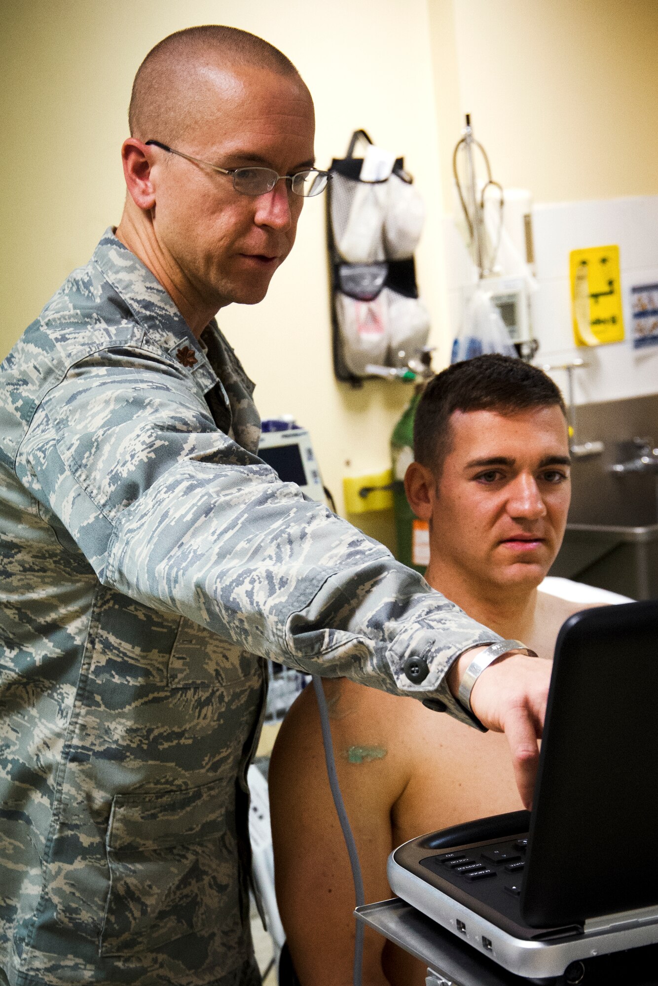 Maj. Sean Martin, 386th Expeditionary Medical Group, reviews an ultrasound image with his patient, Staff Sgt. Caleb Chiellini.  Martin, who is deployed from Eglin Air Force Base, Fla., has recently been honored with Air Force Material Command's Physician Educator of the Year award.  He will go on to compete against other MAJCOM winners in his category for the Air Force level award.  Martin is a native of Port Orange, Fla.  (U.S. Air Force photo by Senior Master Sgt. Burke Baker)