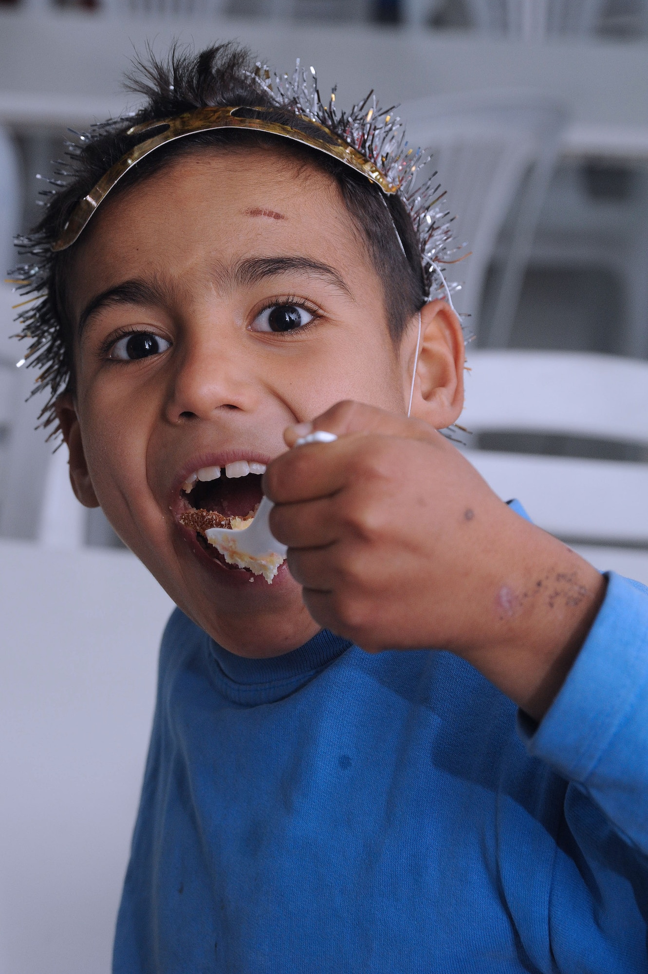 A Turkish boy eats a piece of homemade cake during a New Year’s party held at the Seyhan Isitme elementary school for the hearing impaired Dec. 26, 2013, in Adana, Turkey. A Team Incirlik spouse made the cake that was part of the gifts, decorations and food donated for the event that was facilitated by the Incirlik AB chapel community. (U.S. Air Force photo by 1st Lt. David Liapis/Released)
