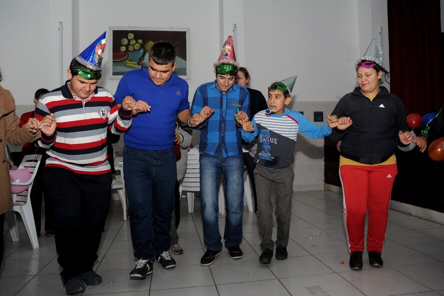 Students at Seyhan Isitme elementary school for the hearing impaired perform a Turkish dance during holiday party Dec. 26, 2013, in Adana, Turkey. The students kept time while dancing by feeling the bass beats of the music being projected by at least eight speakers. (U.S. Air Force photo by 1st Lt. David Liapis/Released)