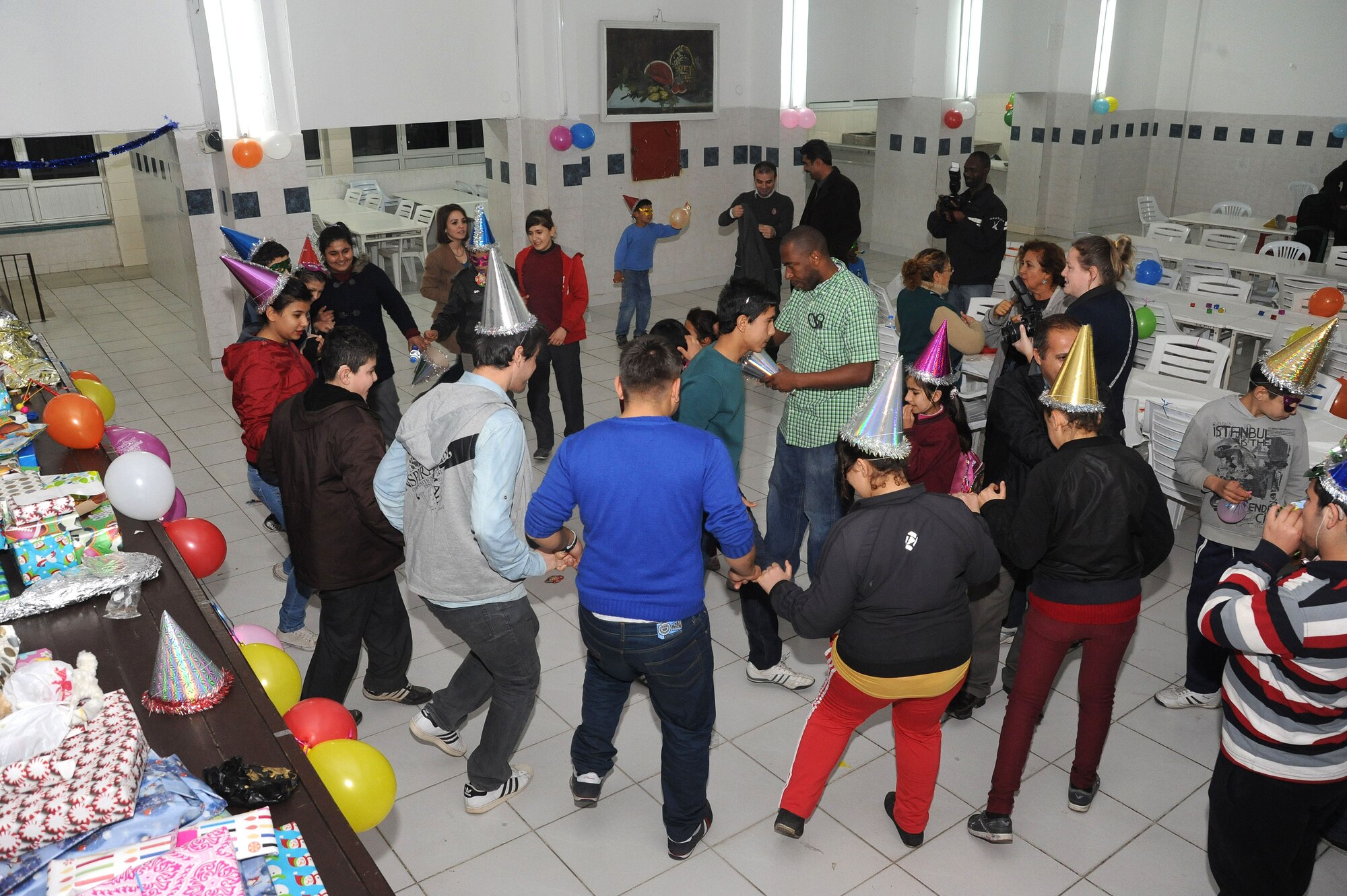 A Turkish youth at the Seyhan Isitme elementary school for the hearing impaired celebrated at a New Year’s party hosted by a group of seven U.S. personnel from Incirlik Air Base at the school Dec. 26, 2013, in Adana, Turkey. Team Incirlik members donated 78 gifts, a variety of decorations, food and games for the event that was facilitated by the Incirlik AB chapel community. (U.S. Air Force photo by 1st Lt. David Liapis/Released)