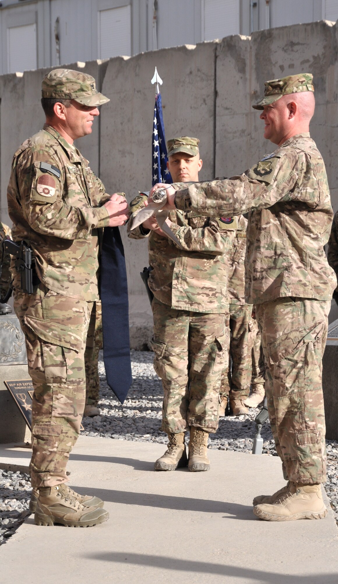Col. Sean Tyler (left), 451st Expeditionary Mission Support Group commander, and  Maj. Richard Zeigler (right), 451st Expeditionary Security Forces Squadron commander, case the squadron guidon during the 451st ESFS deactivation ceremony at Camp Losano, Kandahar Airfield, Afghanistan, Dec. 27, 2013. (U.S. Air Force photo by Capt. Jason Smith)