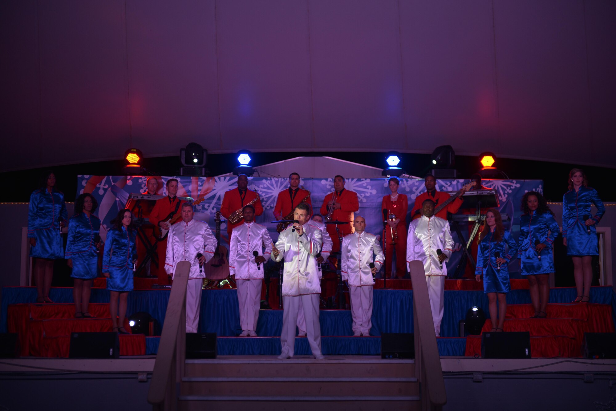 Members of the Air Force Entertainment Group perform for deployed service members at the 379th Air Expeditionary Wing, Southwest Asia, Dec. 26, 2013. The AFEG is comprised of 29 former Tops in Blue members who are prior service, active duty, guard and reserve Airmen who volunteered their time during the holidays to boost morale to deployed personnel. The tour concluded here after 15 performances in 10 locations worldwide. (U.S. Air Force photo by Master Sgt. David Miller)