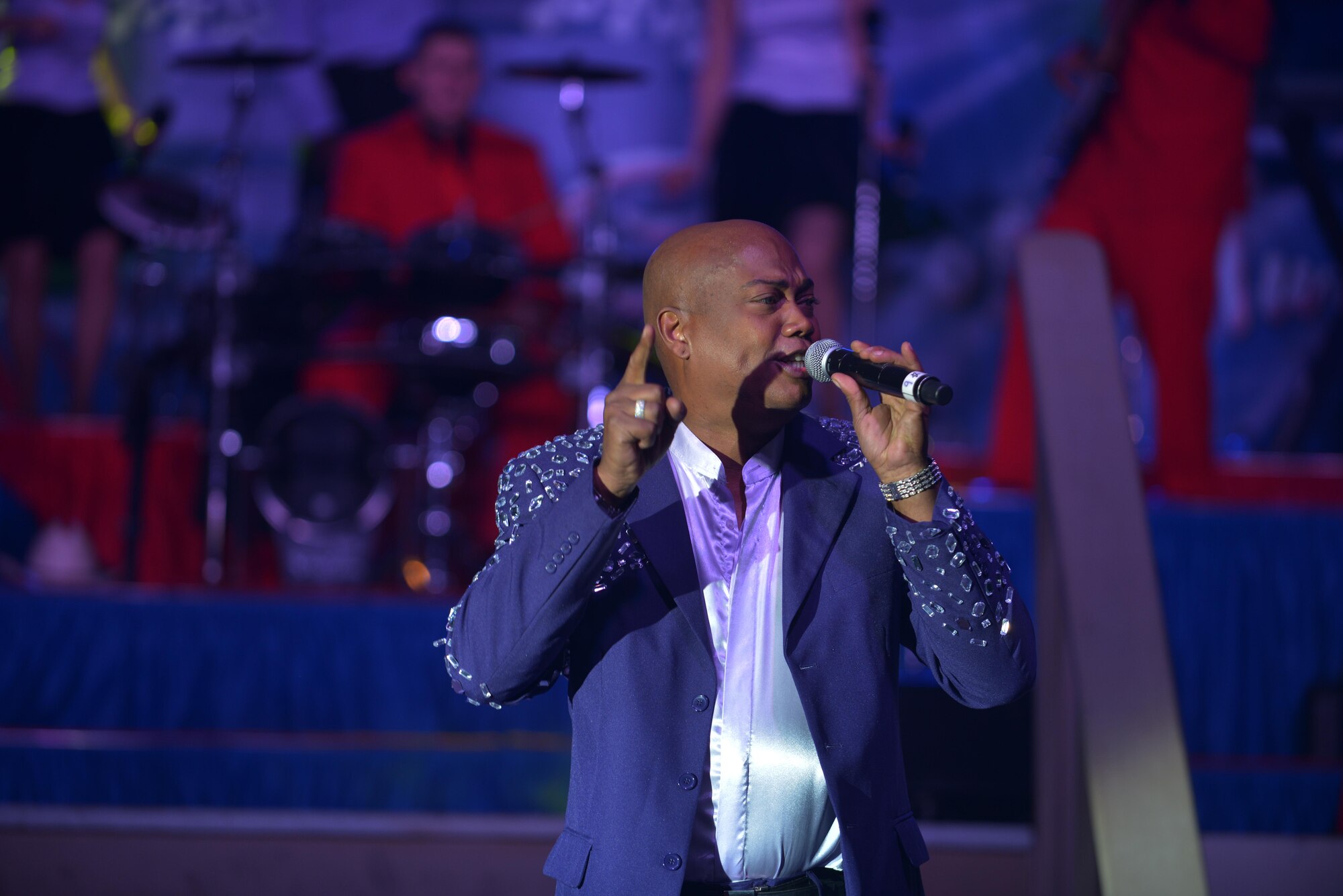 Lane McCray, Air Force Entertainment Group vocalist, sings to deployed service members at the 379th Air Expeditionary Wing, Southwest Asia, Dec. 26, 2013. After an enlistment in the U.S. Air Force, McCray became a member of the European pop group La Bouche.The AFEG is comprised of 29 former Tops in Blue members who are prior service, active duty, guard and reserve Airmen who volunteered their time during the holidays to boost morale to deployed personnel. The tour concluded here after 15 performances in 10 locations worldwide. (U.S. Air Force photo by Master Sgt. David Miller)