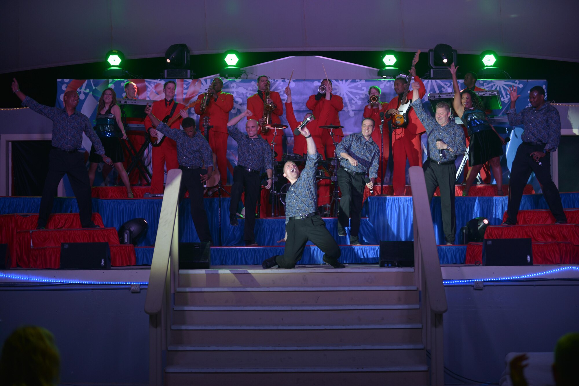 Members of the Air Force Entertainment Group perform for deployed service members at the 379th Air Expeditionary Wing, Southwest Asia, Dec. 26, 2013. The AFEG is comprised of 29 former Tops in Blue members who are prior service, active duty, guard and reserve Airmen who volunteered their time during the holidays to boost morale to deployed personnel. The tour concluded here after 15 performances in 10 locations worldwide. (U.S. Air Force photo by Master Sgt. David Miller)