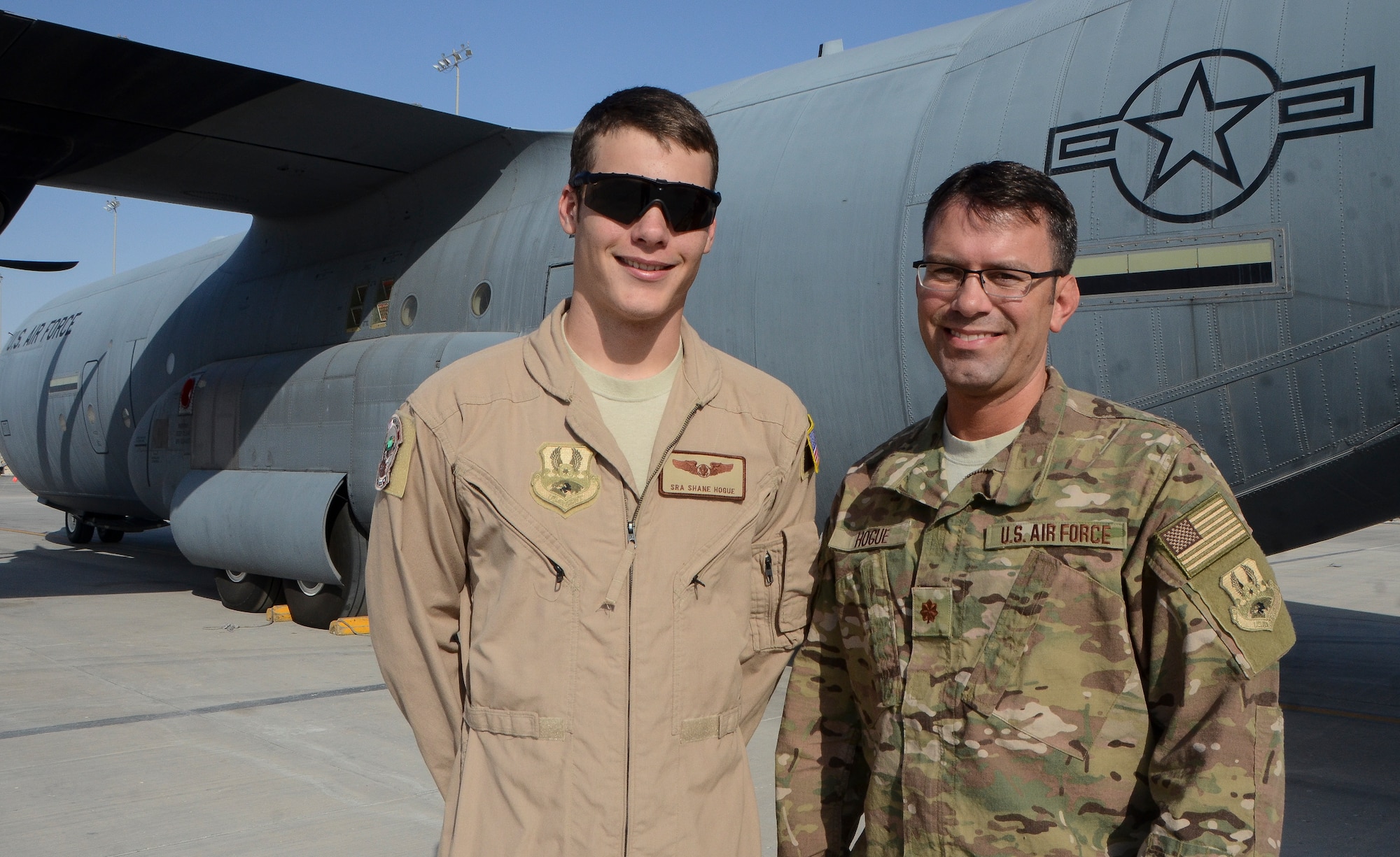 Senior Airman Shane Hogue and his father, Maj. Franklin Hogue, smile in front of a C-130J Super Hercules at the 379th Air Expeditionary Wing in Southwest Asia, Dec. 19, 2013. The family members, deployed from Keesler Air Force Base, Miss. and Biloxi, Miss. natives, are sharing the experience of deploying together during the holidays. Shane is the 746th EAS chief of intelligence and Franklin is a 746th EAS loadmaster. (U.S. Air Force photo/Senior Airman Jared Trimarchi)