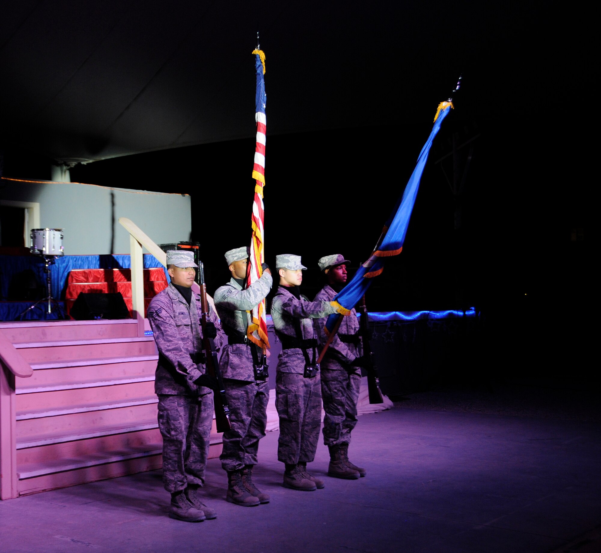 Members of the 379th Air Expeditionary Wing Honor Guard present the colors during the Air Force Entertainment Group’s “A Gift of Music,” performance in Southwest Asia, Dec. 26, 2013. Prior Tops In Blue members make up the AFEG who performed 15 shows in 10 locations worldwide during the holiday season. The 379th AEW was the final stop of the 2013 holiday tour for the 29 volunteers who are prior service, active duty, guard and reserve Airmen. (U.S. Air Force photo/Senior Airman Hannah Landeros)