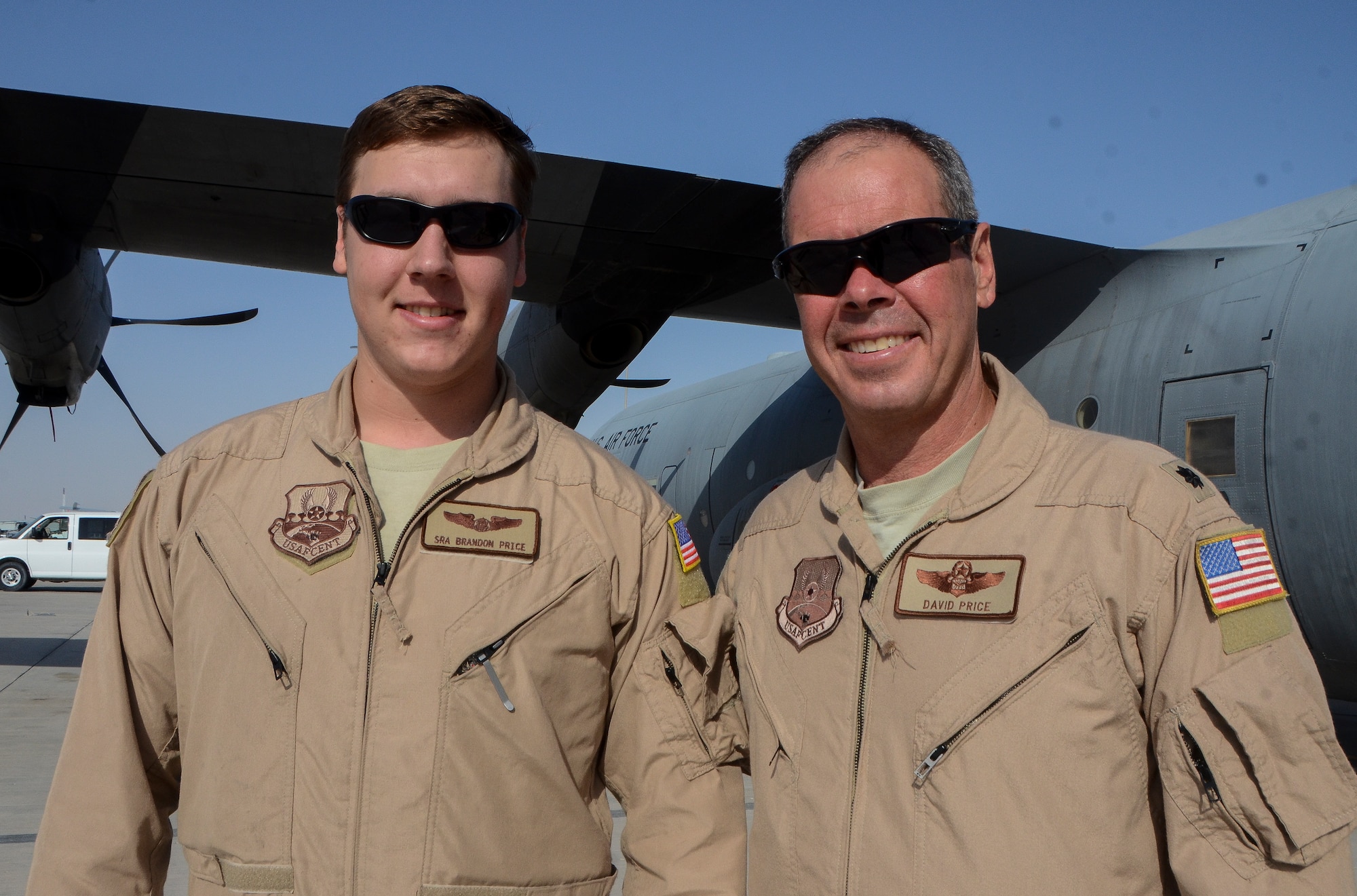 Senior Airman Brandon Price and his father, Lt. Col. David Price, pose in front of a C-130J Super Hercules at the 379th Air Expeditionary Wing in Southwest Asia, Dec. 19, 2013. The family members, deployed from Keesler Air Force Base, Miss. and Ocean Springs, Miss. natives, are sharing the experience of deploying together during the holidays. David is a 746th EAS assistant director of operations and Brandon is a 746th EAS loadmaster. (U.S. Air Force photo/Senior Airman Jared Trimarchi)
