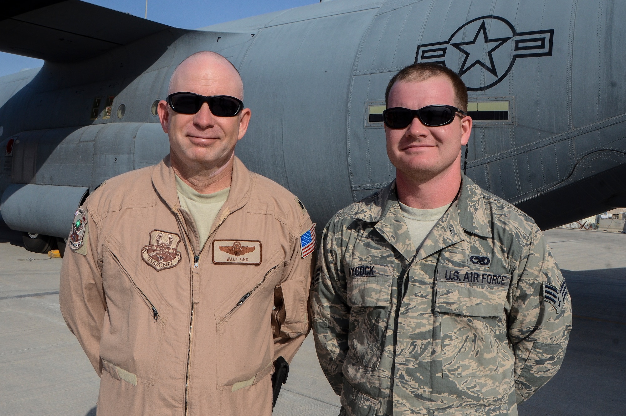 Lt. Col. Walt Ord and his son-in-law, Senior Airman Nick Aycock, pose in front of a C-130J Super Hercules at the 379th Air Expeditionary Wing in Southwest Asia, Dec. 19, 2013. The family members, deployed from Keesler Air Force Base, Miss. and Gautier, Miss. natives, are sharing the experience of deploying together during the holidays. Ord is a 746th EAS assistant director of operations and Ayock is a 379th Expeditionary Aircraft Maintenance Squadron crew chief. (U.S. Air Force photo/Senior Airman Jared Trimarchi)