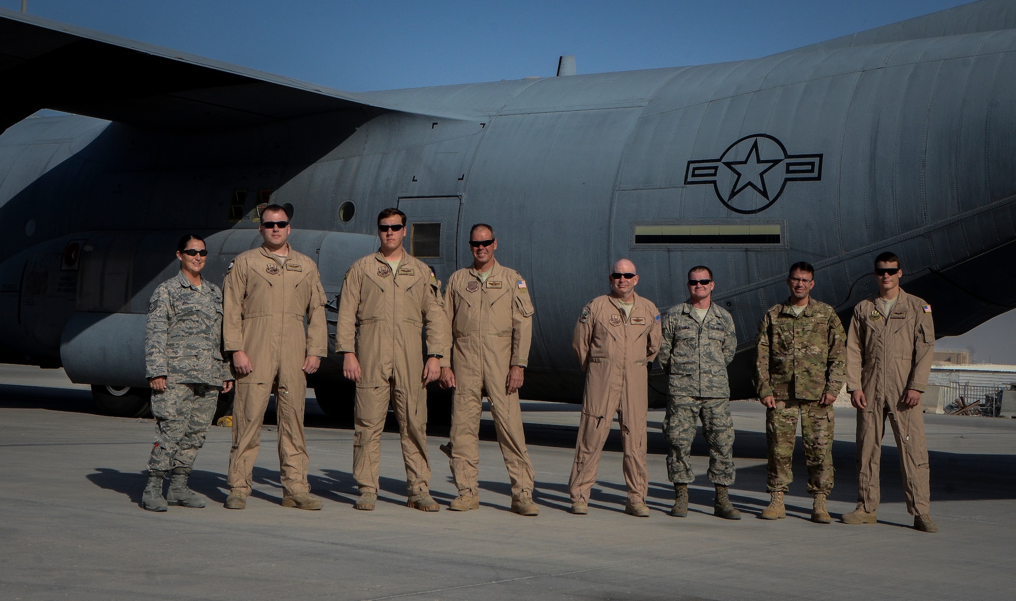 Airmen from the 746th Expeditionary Airlift Squadron and the 379th Expeditionary Aircraft Maintenance Squadron, who are deployed from Kessler Air Force Base, Miss., pose for a group photo in front of a C-130J Super Hercules at the 379th Air Expeditionary Wing in Southwest Asia, Dec. 19, 2013. The group of Airmen share the experience of getting to deploy with a family member during the holidays. From left to right are: Tech. Sgt. Rachel Parish and Master Sgt. Brandon Parish(wife and husband), Senior Airman Brandon Price and Lt. Col. David Price (son and father), Lt. Col. Walt Ord and Senior Airman Nick Aycock (father-in-law and son-in-law), Senior Airman Shane Hogue and Maj. Franklin Hogue (son and father). (U.S. Air Force photo/Senior Airman Jared Trimarchi) 