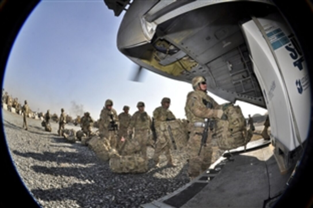 U.S. soldiers prepare to board a CH-47 Chinook from Camp Phoenix in Kabul, Afghanistan, Dec. 25, 2013, during Guam's last push out of the country. The soldiers are assigned to Task Force Guam, 1st Battalion, 294th Infantry Regiment, Guam Army National Guard. The task force officially ended Operation Enduring Freedom, Dec. 26, 2013, enabling Guardsmen to return home.