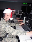 Senior Airman Kyle Hesse and Senior Airman Phillip Gentile of the New York Air National Guard take part in Santa tracking training Dec. 19, 2013, at the Eastern Air Defense Sector.