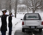 New York Army National Guard Spc. Christopher Roderiguez and Pvt. Shelbi Vanderbogart salute as the remains of Army veteran Harold Smith arrive for graveside services in Hudson, N.Y., Dec. 17, 2013. Smith's funeral was one of 9,735 that the New York Military Forces Honor Guard's 35 full-time and 135 part-time members performed for families across New York, as of Dec. 23.