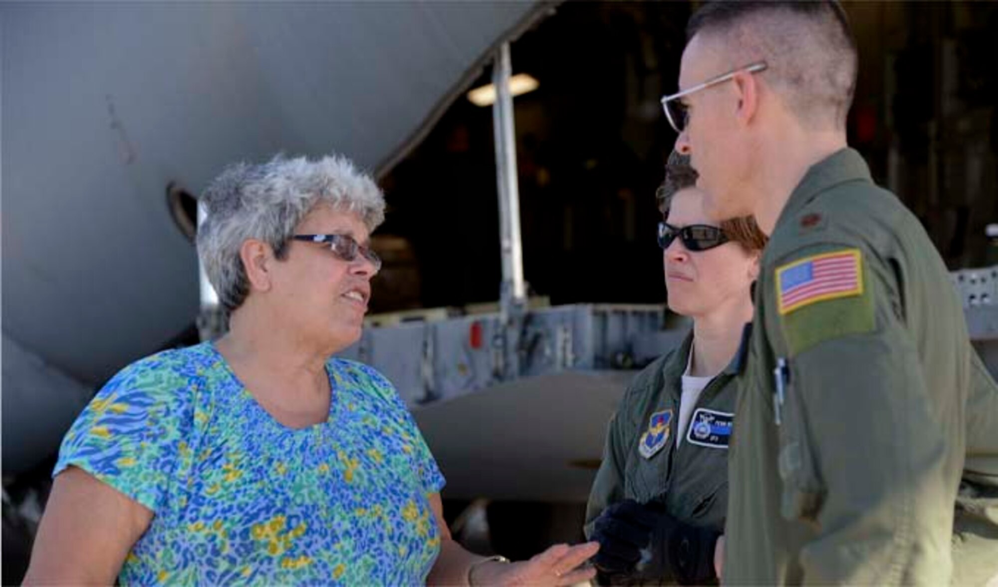 Kathy Cadden (left) meets with Maj. Jody Turk and Tech. Sgt. Penni Williams on Dec. 19, 2013, at Port-au-Prince, Haiti. Turk and Williams, along with other members assigned to the 97th Air Mobility Wing, supported a humanitarian aid delivery that consisted of 136,000 pounds of rice, beans and corn meal, donated by Operation Ukraine, that will be distributed to various orphanages in Haiti. Cadden is the founder and president of Operation Ukraine, Turk is the assistant director of operations at the 730th Air Mobility Training Squadron and Williams is a 97th Security Forces Squadron mid-shift flight chief. (U.S. Air Force photo/Airman 1st Class Klynne Pearl Serrano)