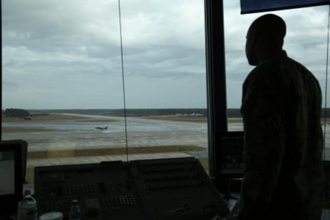 Staff Sgt. Ralph F. Pyles III, an approach controller with the Air Traffic Control tower, watches as an aircraft touches down on a Cherry Point runway Nov. 21.


